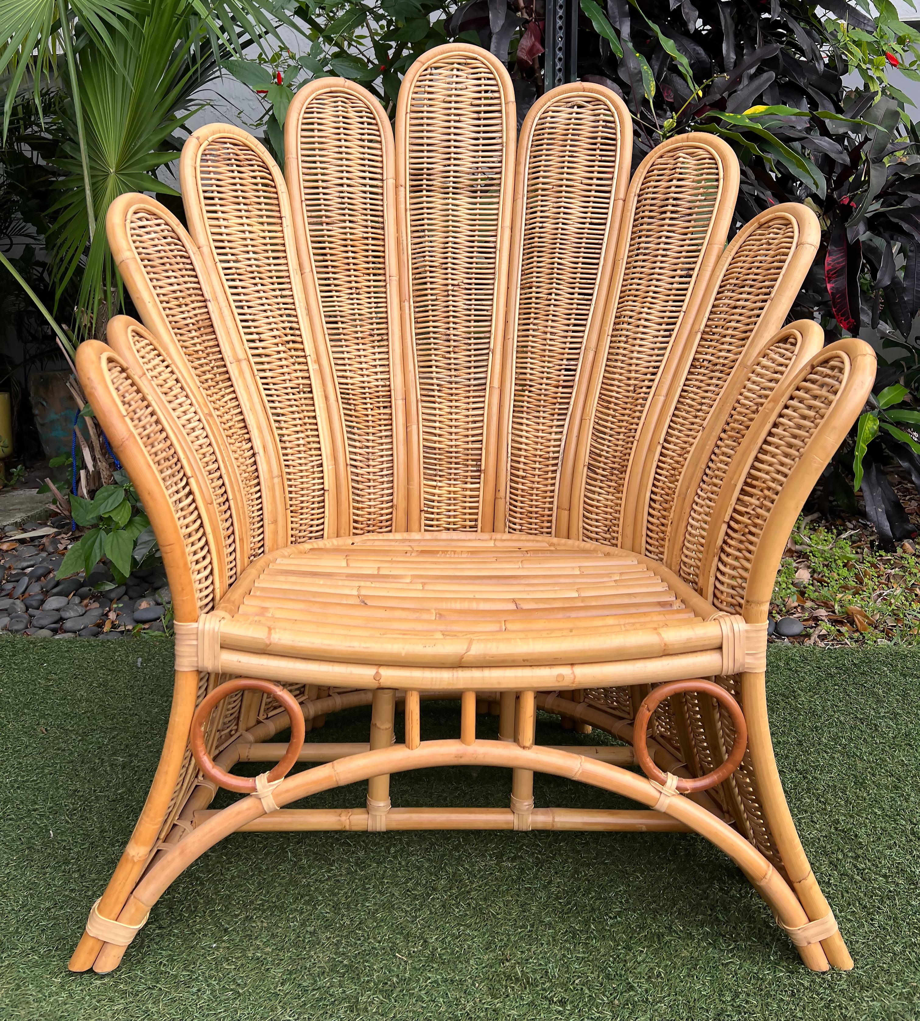 Vintage Mid-Century Rattan Peacock Fan Back Chair

Offered for sale is an elegant and impressive mid-century bent rattan peacock fan back chair with splayed legs at match the curves of the top back fan. The curved panels are finished with woven