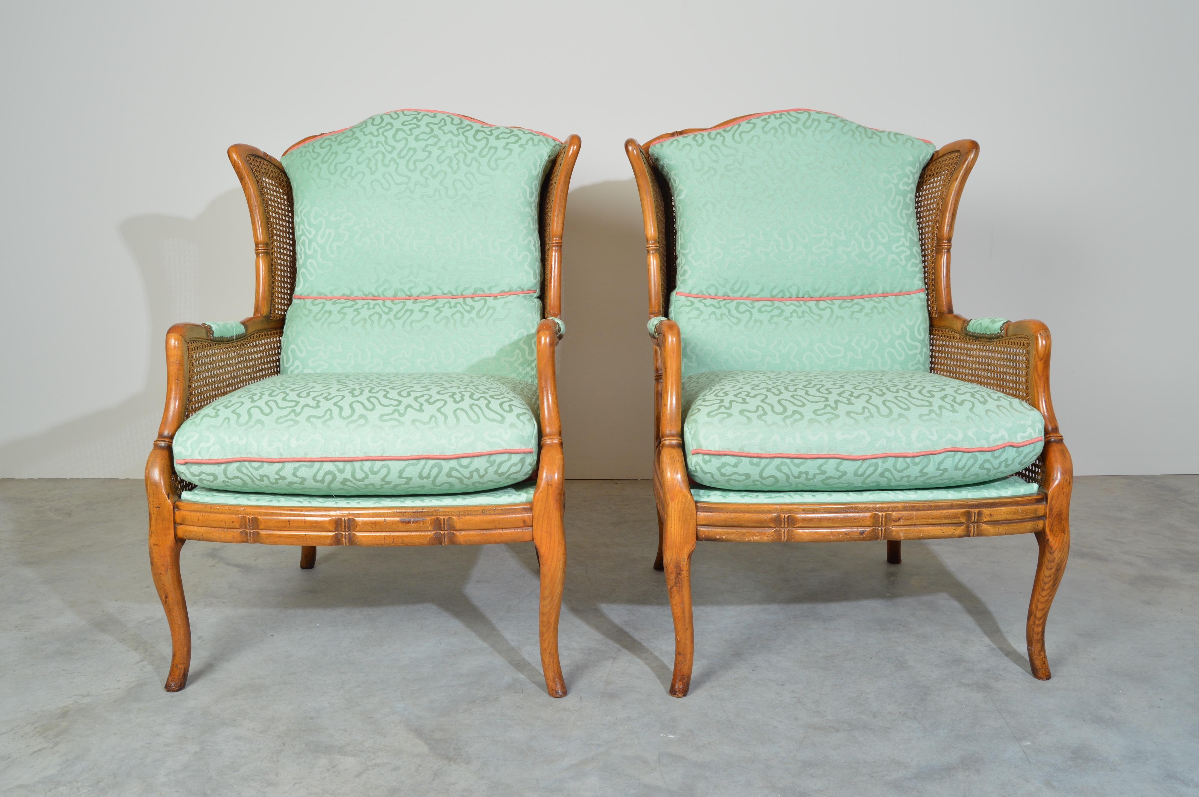 Regency style vintage faux bamboo wood frame wingback chairs with nicely scalloped crests and unusual full body caning.
New designer textured Keith Haring style upholstery. The chairs have been fully detailed and are in excellent