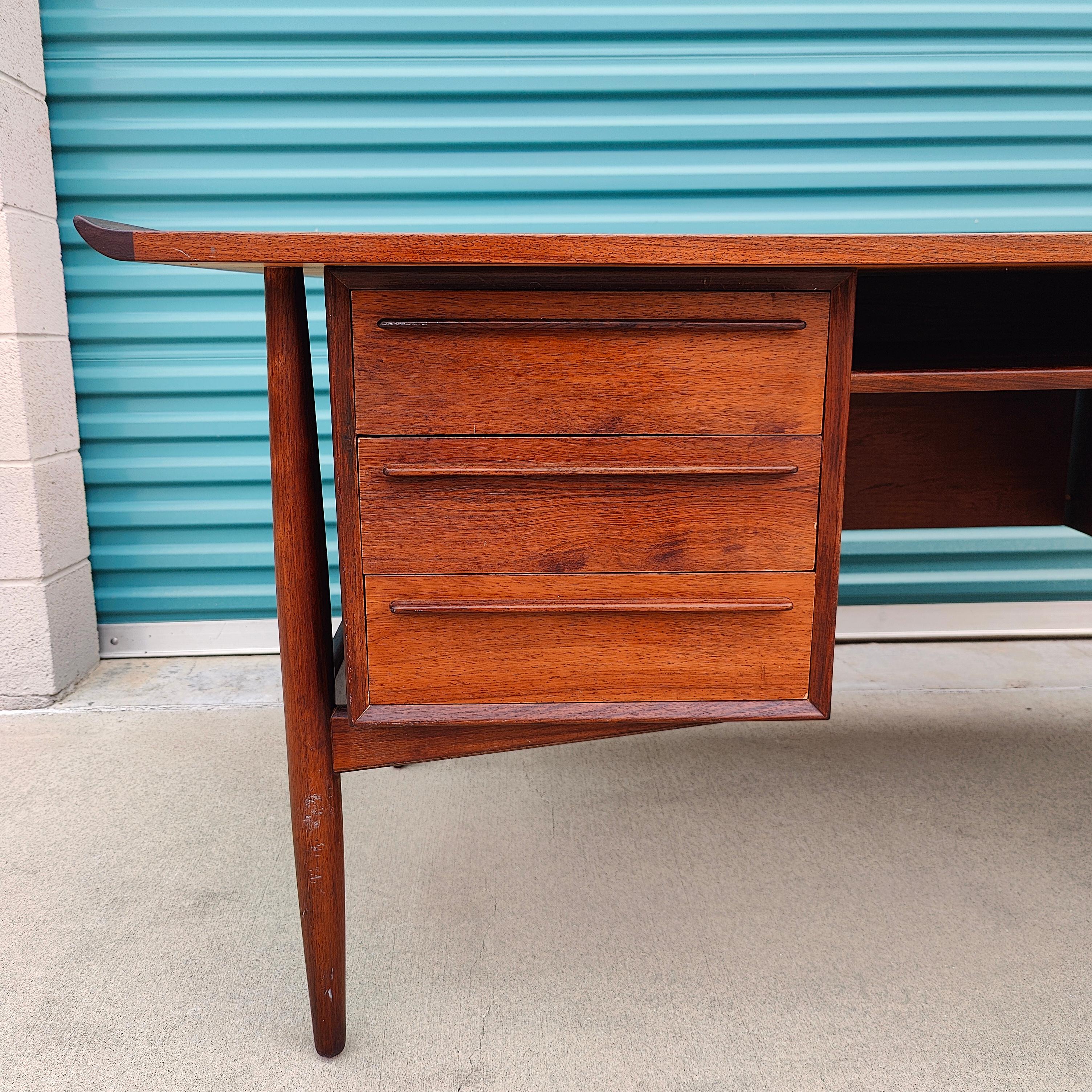 Just in, a desk designed by Arne Vodder for H.P. Hansen, c1960s. Being offered in original condition and priced accordingly. Measures approximately 60w x 29.5d x 28.25h. Features a beautiful rosewood grain finish with 3 dovetailed drawers and filing