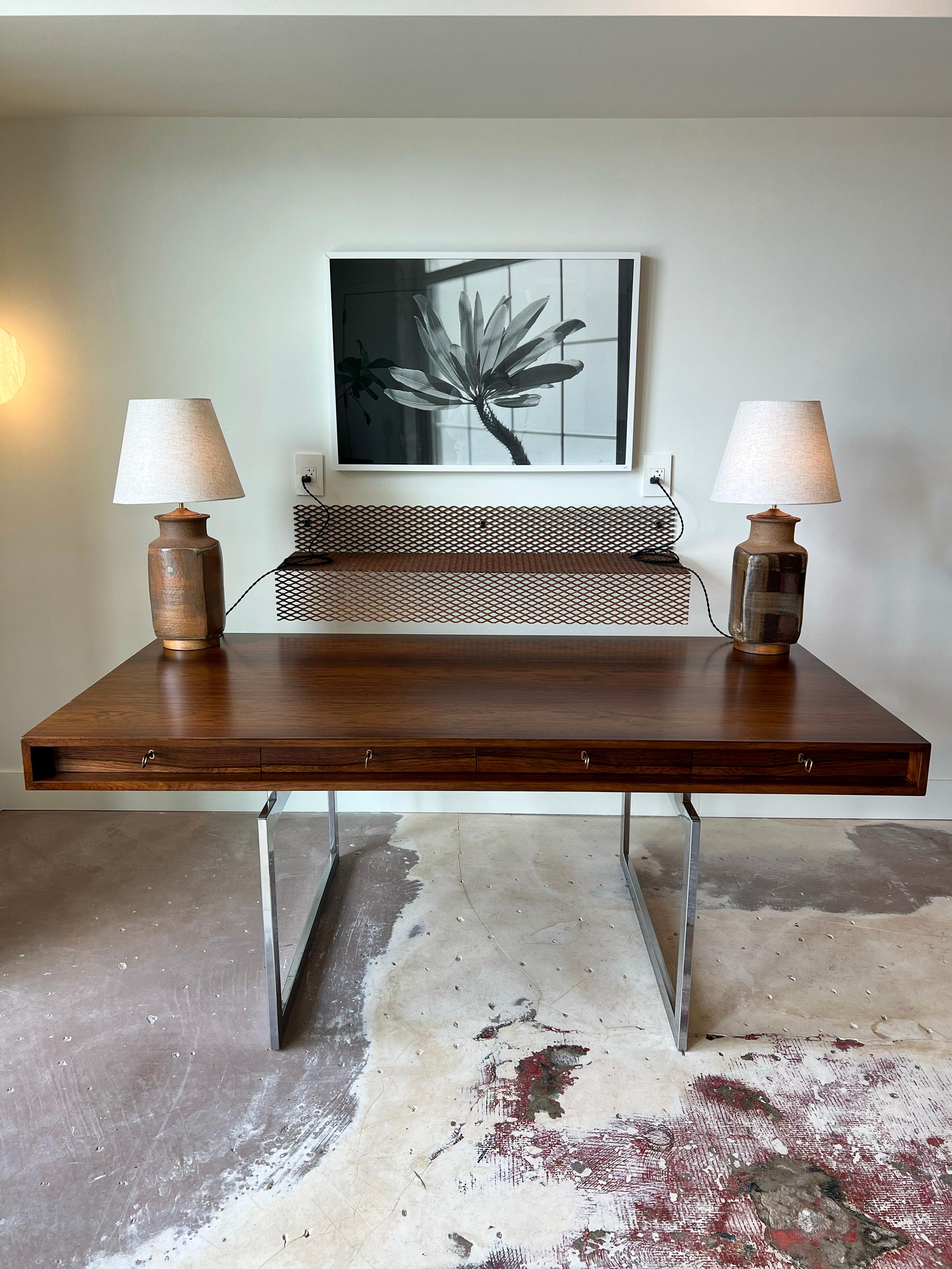 Vintage Executive Desk / Working Table by Bodil Kjaer for E. Pedersen & Son. Beautiful grain and contrast in the rosewood surface on this classic and important example of modernist design. Chrome base has some patina and is in original condition