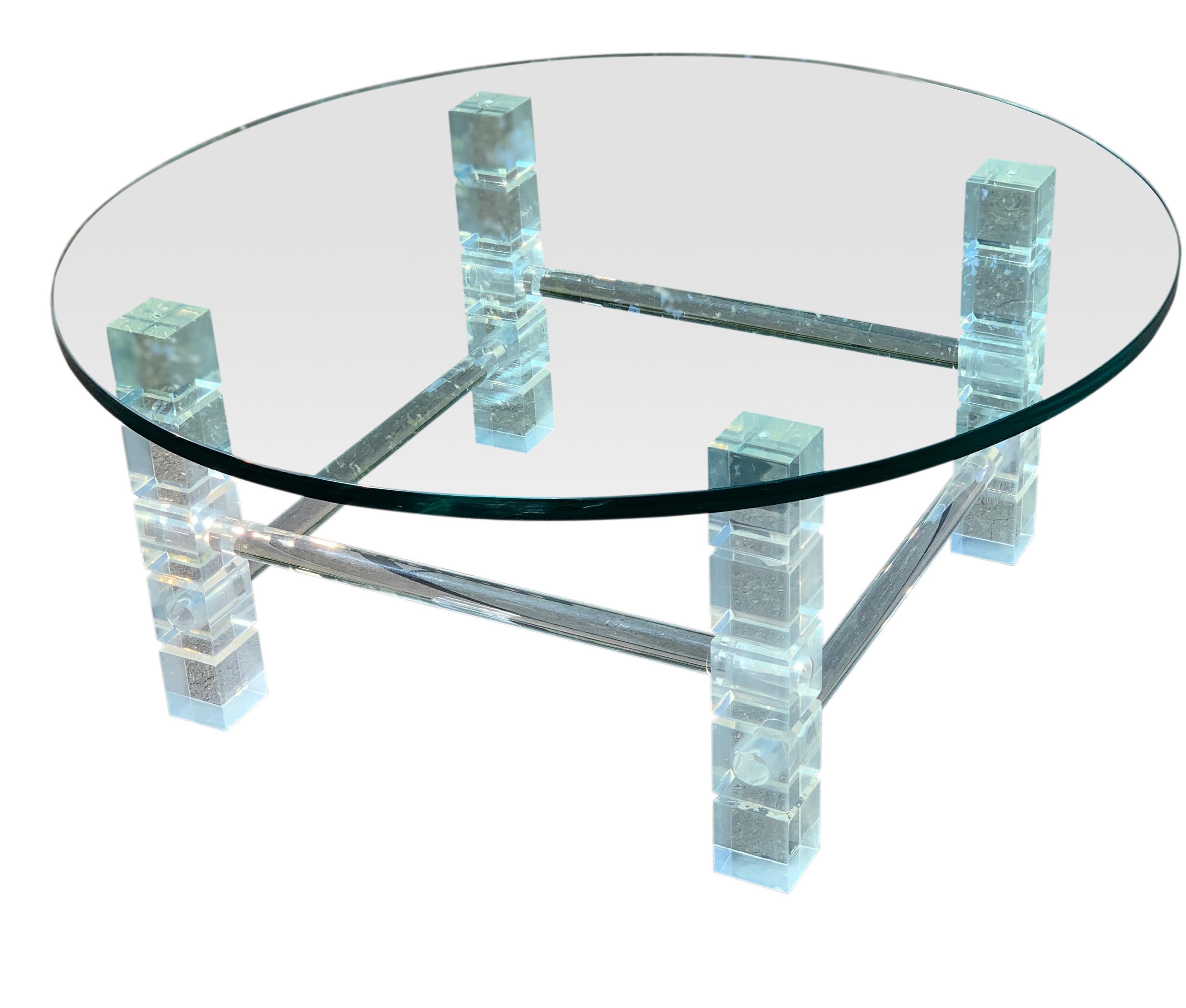 Fabulous vintage glass coffee table with a beveled lucite geometric design base. The unique lucite base has alternating horizontal bars between chunky sculptural posts. The round glass is a heavy 3/4” thick. A sleek table with great vintage modern