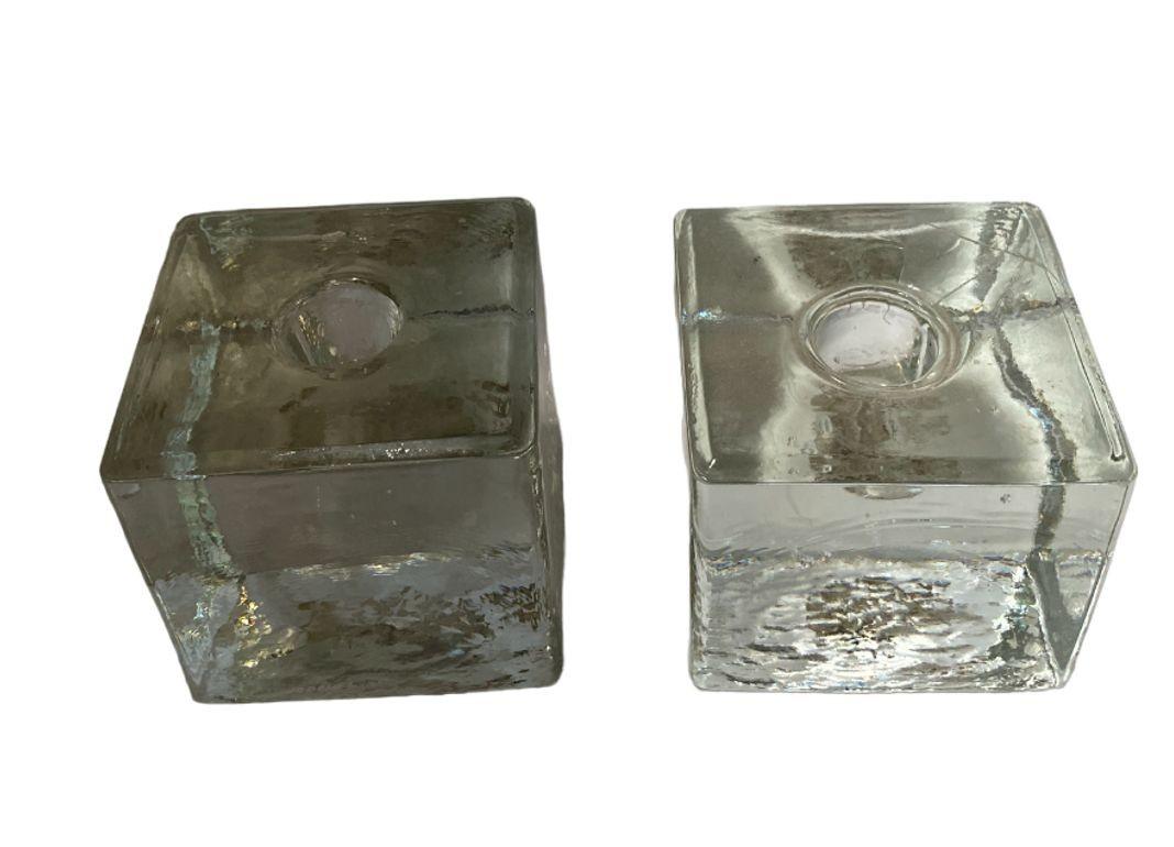 Embrace the allure of yesteryear with our Vintage Cube Crystal Candlestick Holder Pair. Crafted to perfection, these exquisite candle holders showcase a timeless design that seamlessly integrates into any decor. The clear glass cubes evoke a sense
