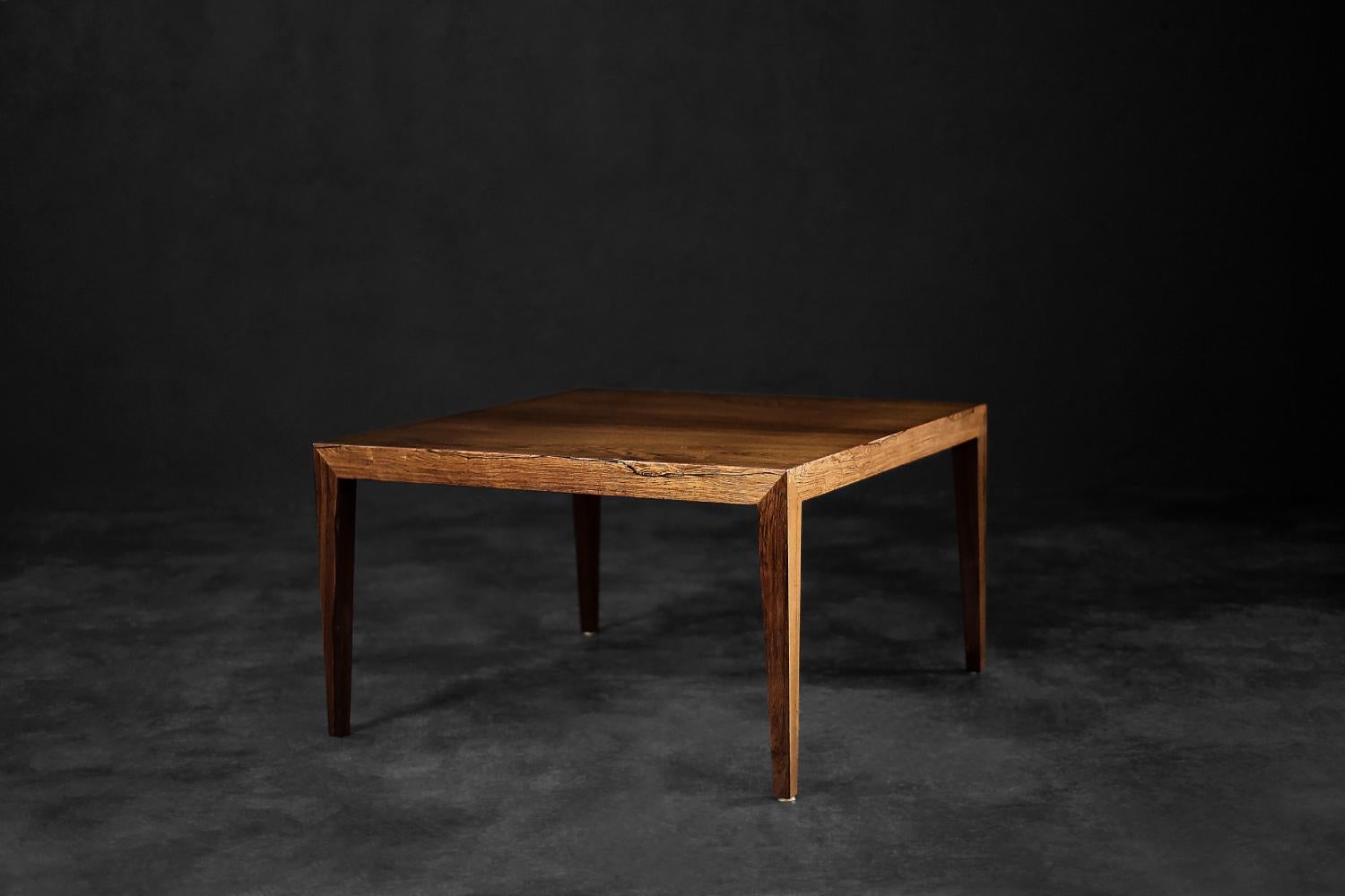 This classic coffee table was designed during the 1960s by Severin Hansen for the Danish manufacturer Haslev Møbelsnedskeri. The geometric table is made of precious rosewood in a warm shade of brown. Characteristic for Hansen, the angular connection