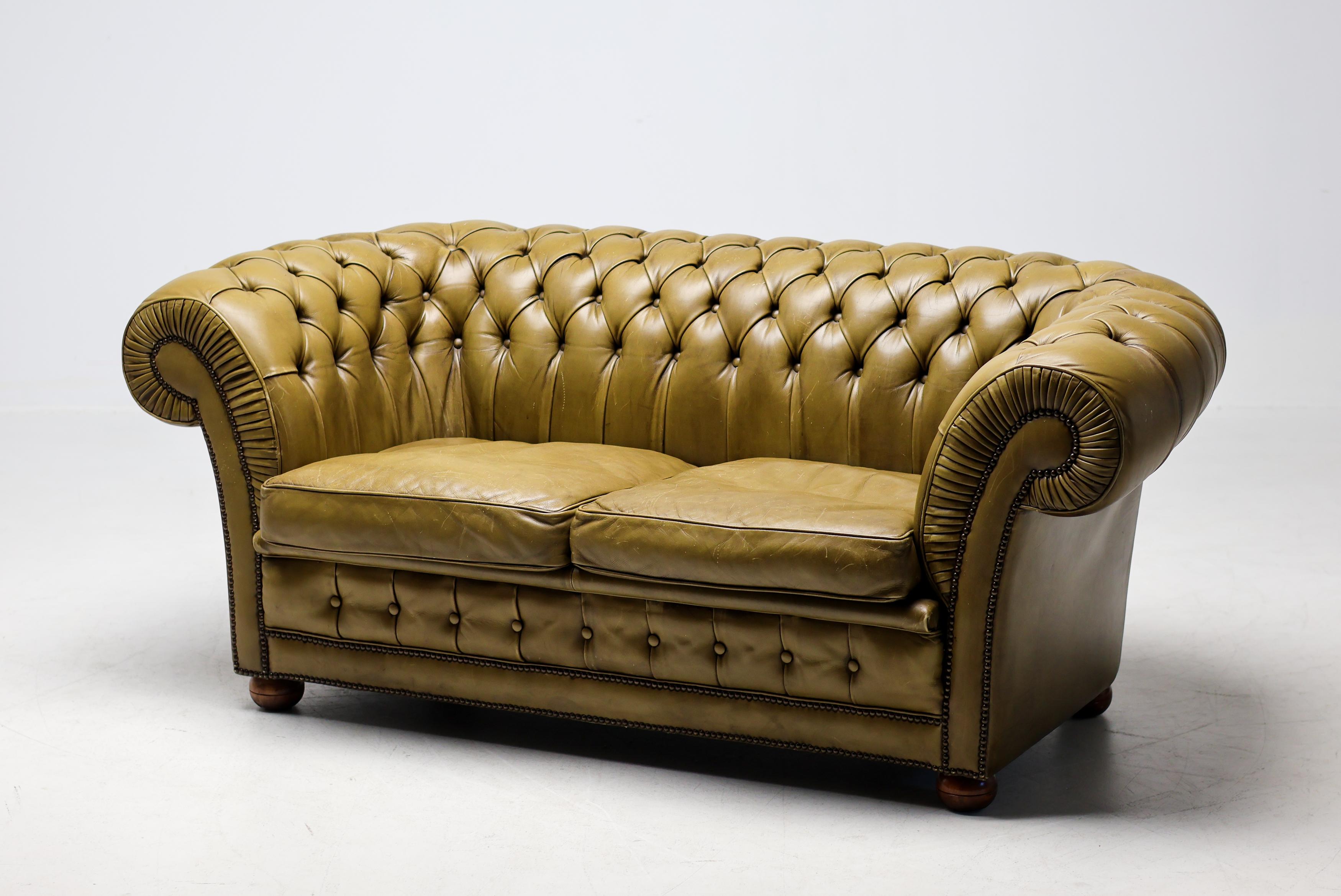 Timeless, sophisticated, and steeped in character—this vintage Chesterfield sofa in rich green leather embodies classic British design at its finest. The deep button tufting, rolled arms, and low profile capture the iconic silhouette that has made
