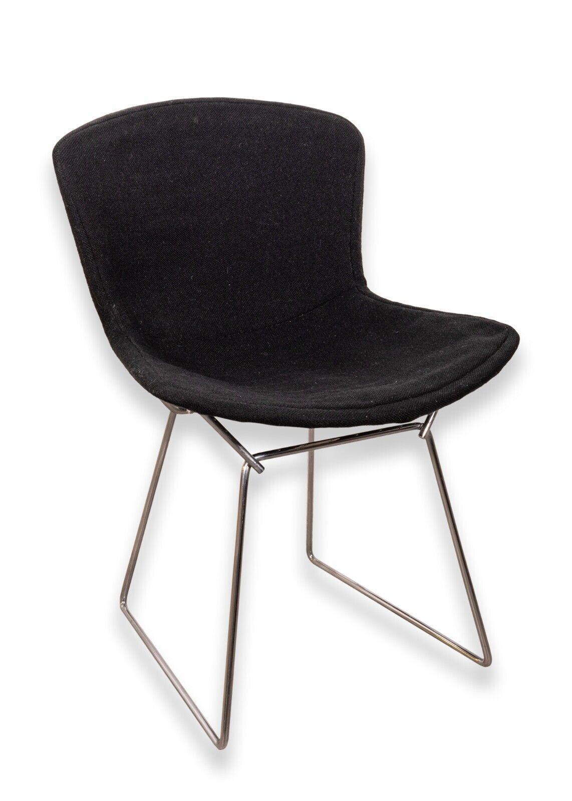 Set of 4 Vintage Knoll Bertoia wire side chairs with black seat covers. An amazing set Harry Bertoia chairs featuring his iconic wire construction and design. These chairs have original Knoll tagging on the underside. They additionally feature very