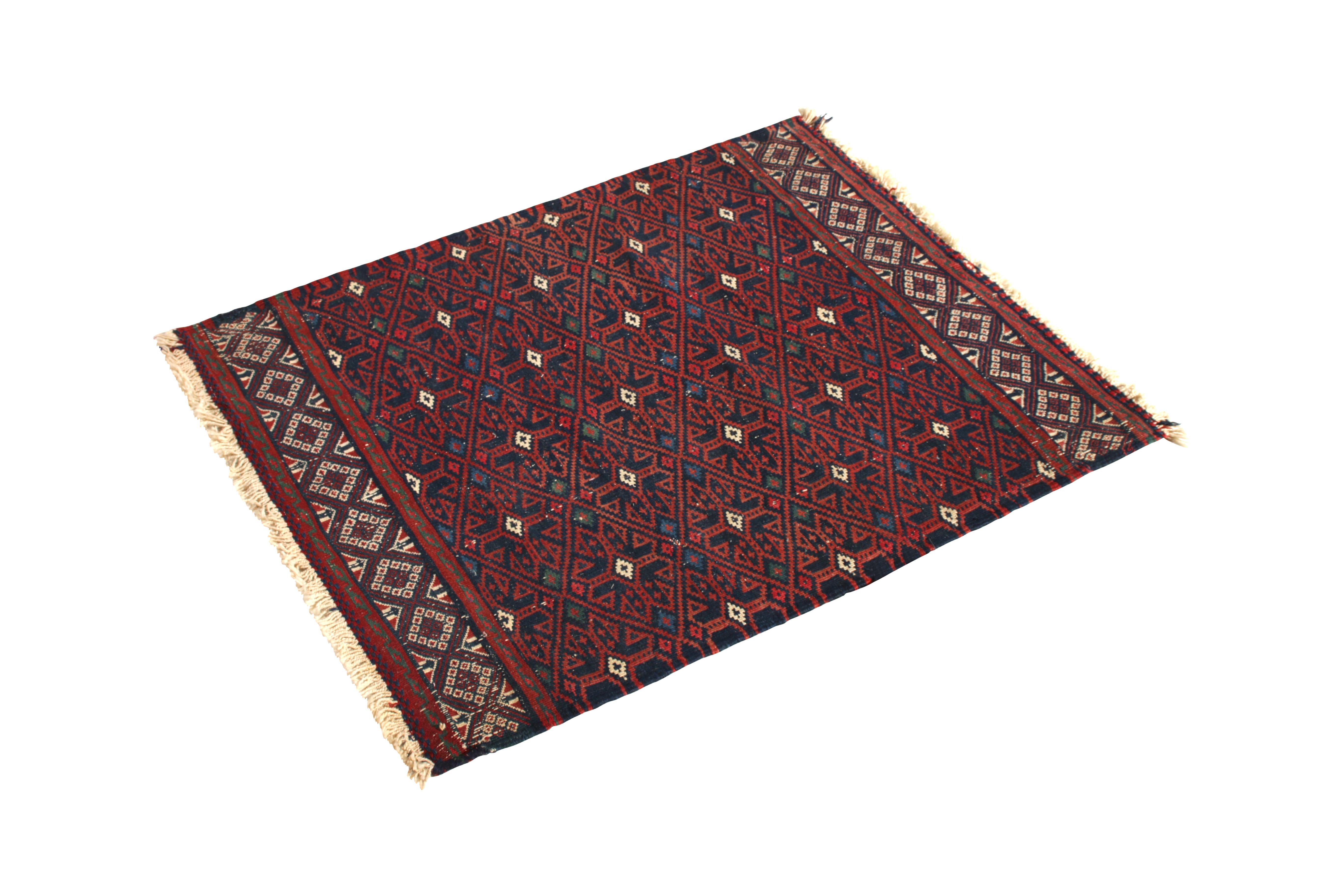 Handwoven in Turkey originating between 1950-1960, this vintage midcentury Kilim rug enjoys a Soumak style weave thicker and more durable than typical Kilim, a fine complement to the Classic play of crimson red and blue as well as the crisp white