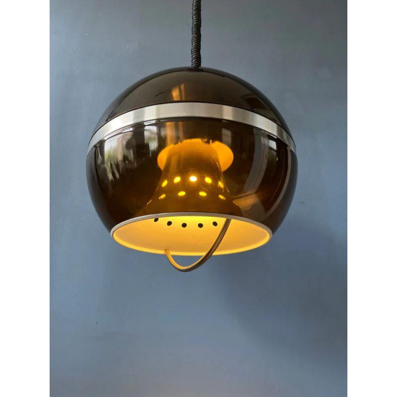 Amazing space age pendant light by Dijkstra called 'The Globe'. The lamp consists of a transparent outer shade and an inner chrome shade. The height of the lamp can be adjusted with the rise-and-fall system. The lamp requires one E27/26