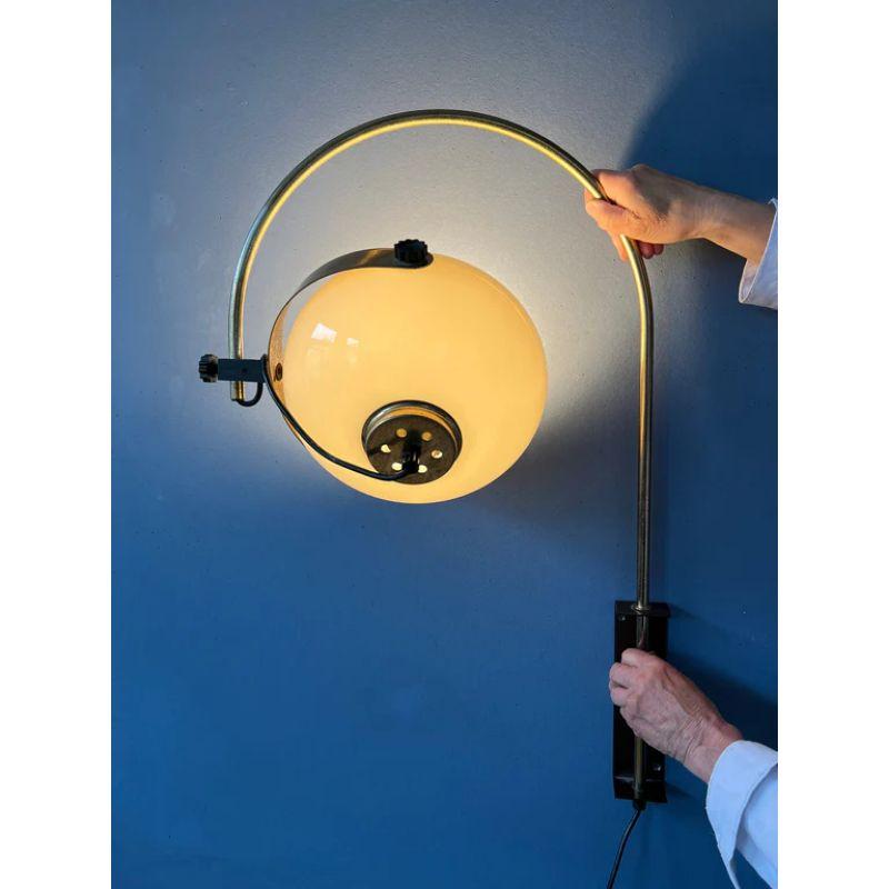 Special arc wall light by Dijkstra with mushroom shade and gold plated arc frame. The shade can be positioned inside or outside the arc and turned in different directions. The lamp requires an E27 lightbulb and currently has an