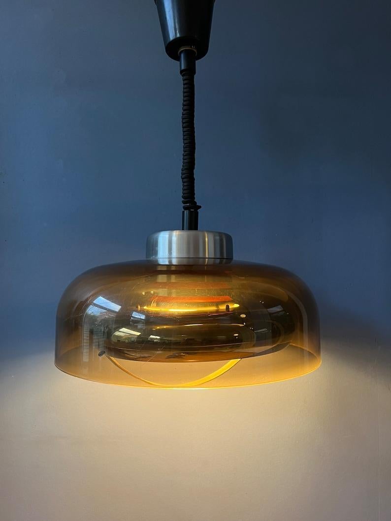 Beautiful space age pendant by the Dutch brand Herda. The lamp has an acrylic glass outer shade and an aluminium inner shade. The lamp requires one E27 lightbulb.

Additional information:
Materials: Metal, plastic
Period: 1970s
Dimensions: ø 39