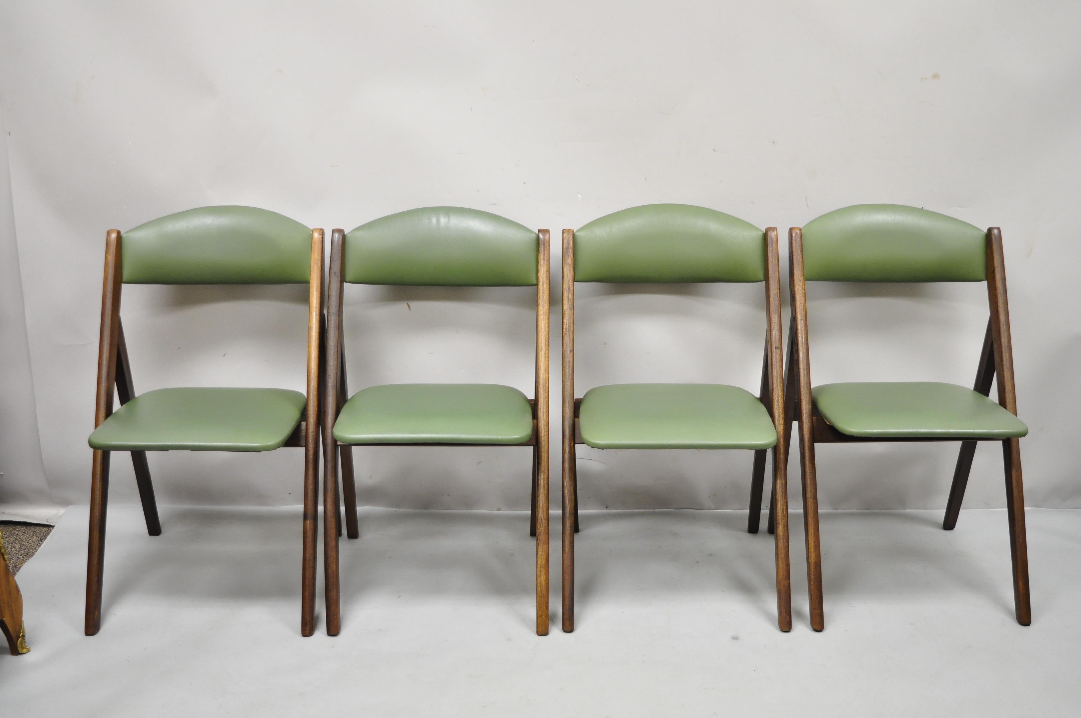 Vintage mid century stakmore wood folding dining game table chairs - Set of 4. Item features green naugahyde vinyl upholstery, solid wood folding frames, beautiful wood grain, original label, clean modernist lines, quality American craftsmanship,