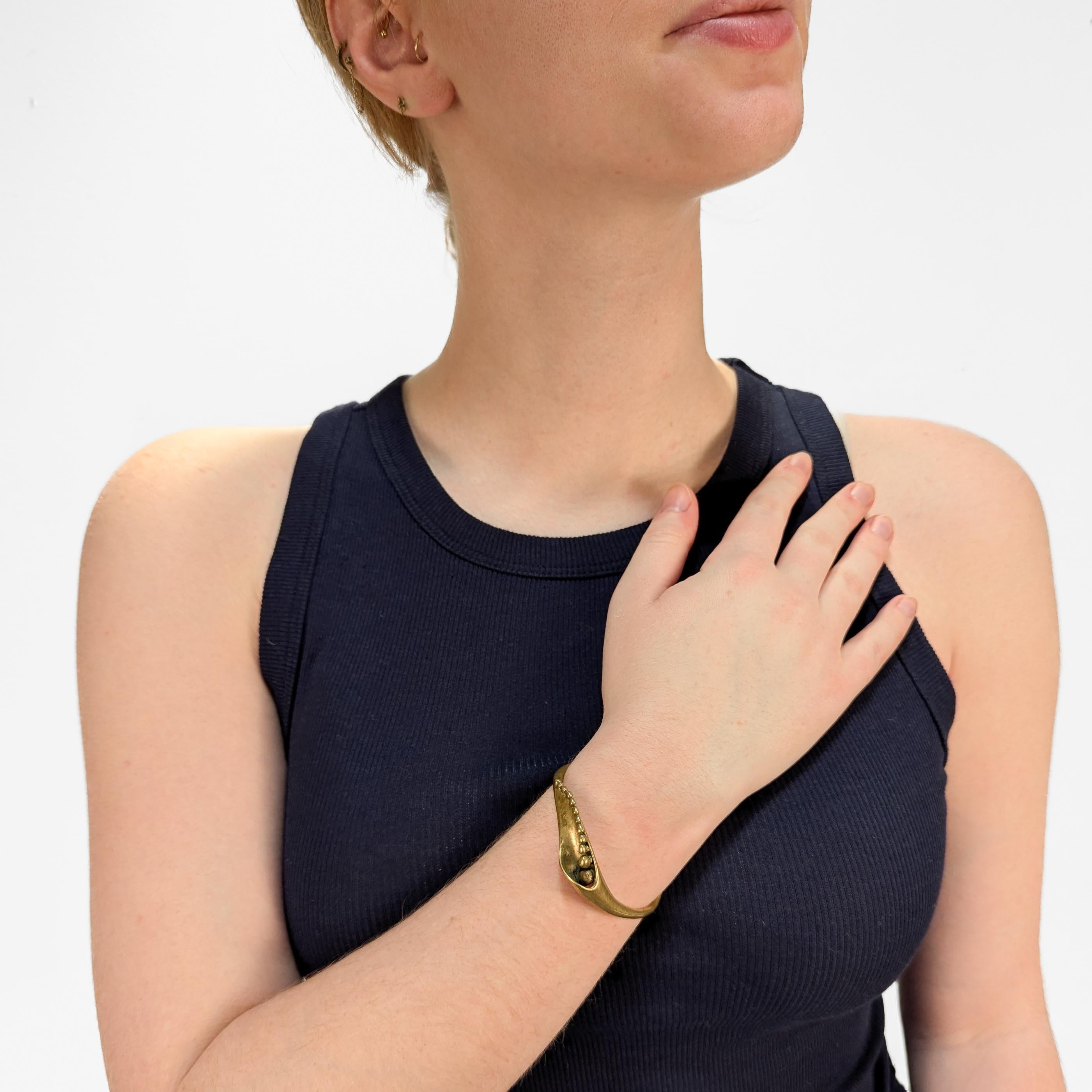 A fine Brutalist cuff bracelet.

In cast brass. 

Attributed to Stephen Burr.

Simply a wonderful Modernist bracelet!

Date:
20th Century

Overall Condition:
It is in overall good, as-pictured, used estate condition.

Condition Details:
There is
