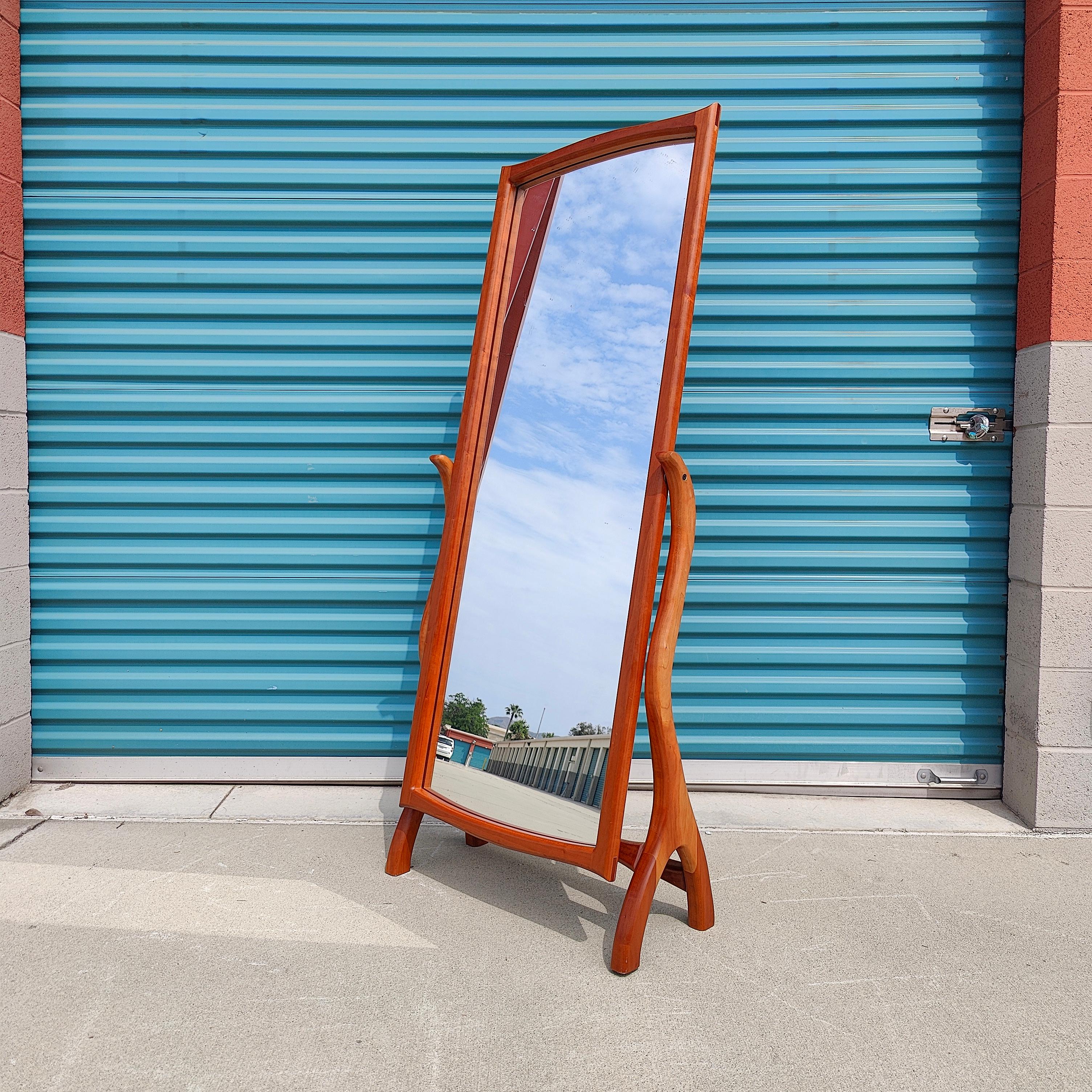 Just in, an extraordinary studio made mirror. Sourced from the original owner, this sleek mirror features curvaceous frame that is simple, yet elegant in design. Made out of solid walnut, this mirror also features a tilting option to adjust to your