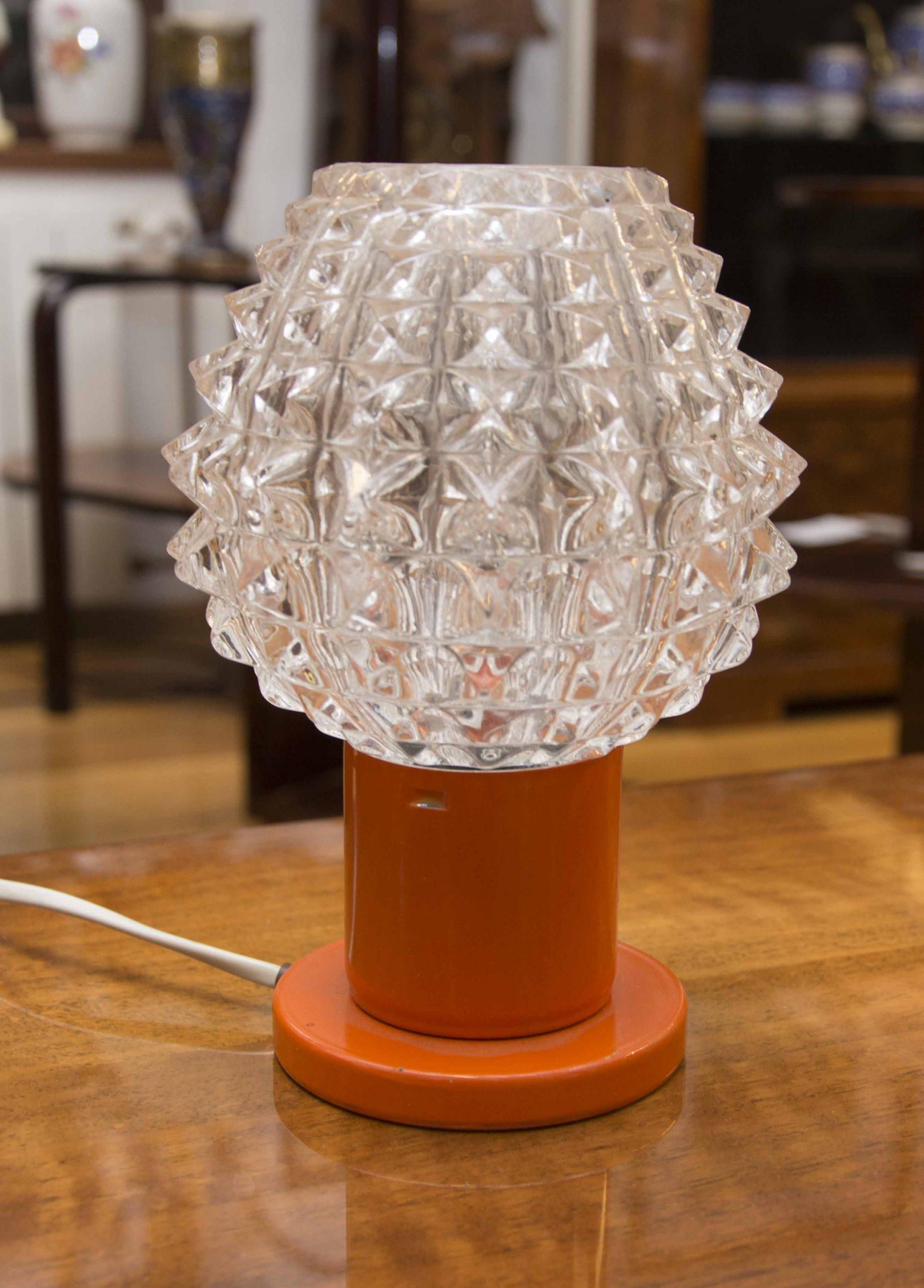 Vintage mid century table lamp from the 1960´s. It was produced by Kamenicky Šenov. The lamp is fully functional. Very well preserved condition. Cut glass, plastic stand. One E-14 Bulb. 250 V.
 