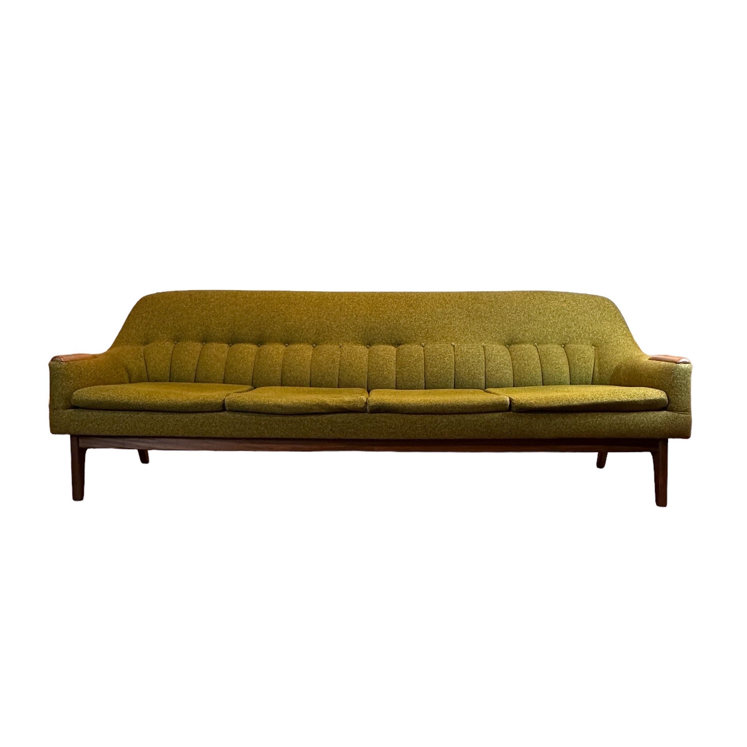 Condition: Great Vintage Condition

Dimensions: 97” L x 27” D x 33” H (15” SH)

Description: A great quality teak 4 seater sofa. Solid teak arm rests and base. Made in Canada, Circa 1960s. Rich olive green colour.