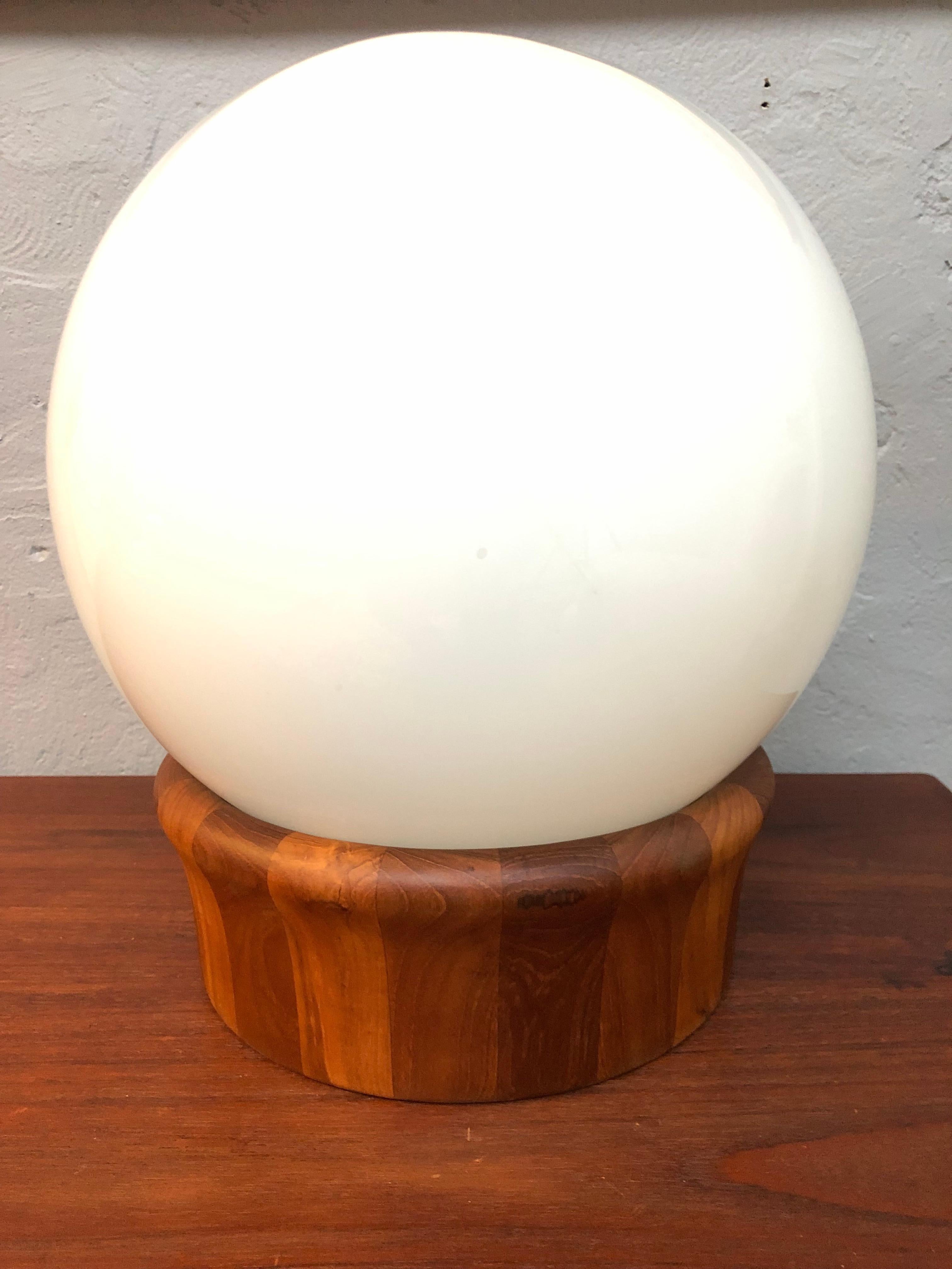A vintage teak and opaline glass table or floor lamp from Johansen Wood of Denmark. 
The base is in turned teak and the shade or defuser is in opaline hand blown glass. 
A great mid century feel. 
Rewired with a brown twisted cloth flex and with a