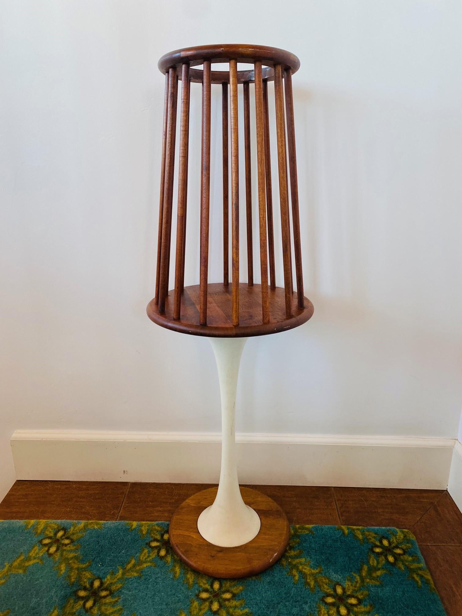 Incredible tulip based vintage planter .  This piece is sculptural and epic.  A tulip style base holds a planter base that is sculpturally created of wood rods.  The end result is a piece that evokes style and Mid Century sensibility.   Utility that