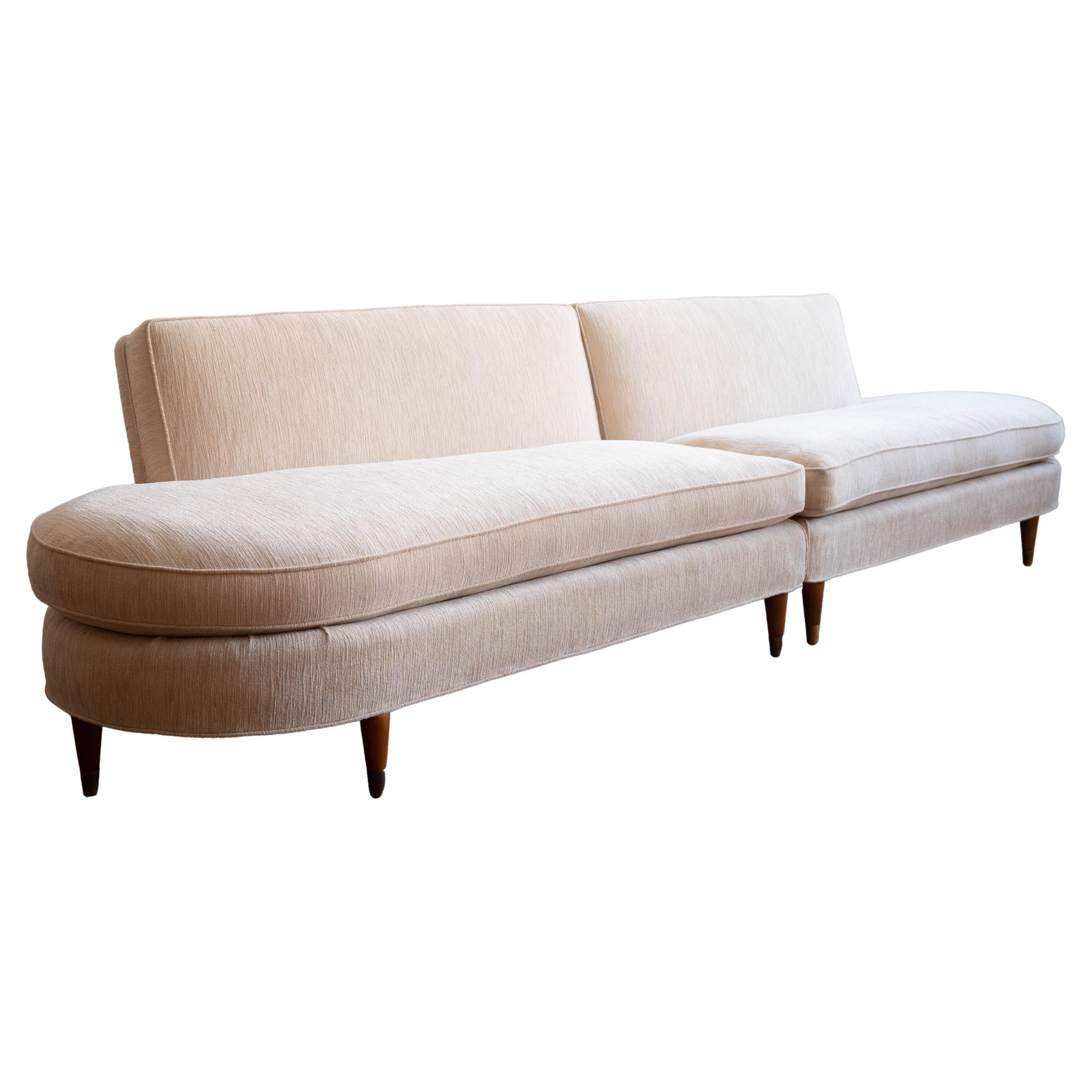 Relax in luxurious, vintage-inspired style with this two-piece curved sectional sofa! Crafted with off-white textured velvet fabric and wood tapered brass-capped legs, this living room staple gives you all the cozy, midcentury vibes you love. Plus,
