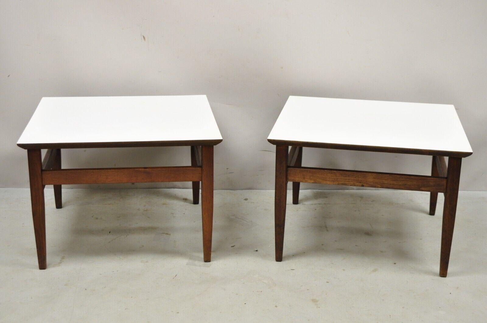 Vintage Mid Century Walnut Base Laminate Top Low Side Tables - a Pair. Item features a nice low form, white laminate tops, stretcher base, tapered legs, very nice vintage pair, clean modernist lines. Circa Mid 20th Century. Measurements: 14.5