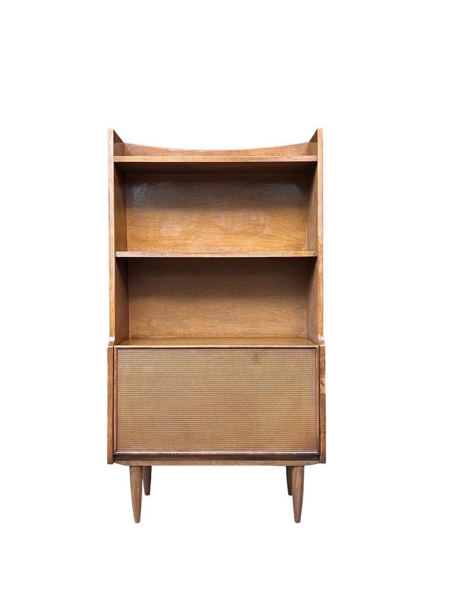 Vintage Mid-Century Modern walnut book case shelf with Caned Door and Bar Cabinet

Dimensions. Over All 31 W ; 11 D ; 58 H
Top Shelf. 29 1/2 W ; 7 1/4 D
2nd Shelf. 29 1/2 W ; 9 D
3rd Shelf 29 1/2 W ; 10 D
Cabinet Over All 29 1/2 W ; 11