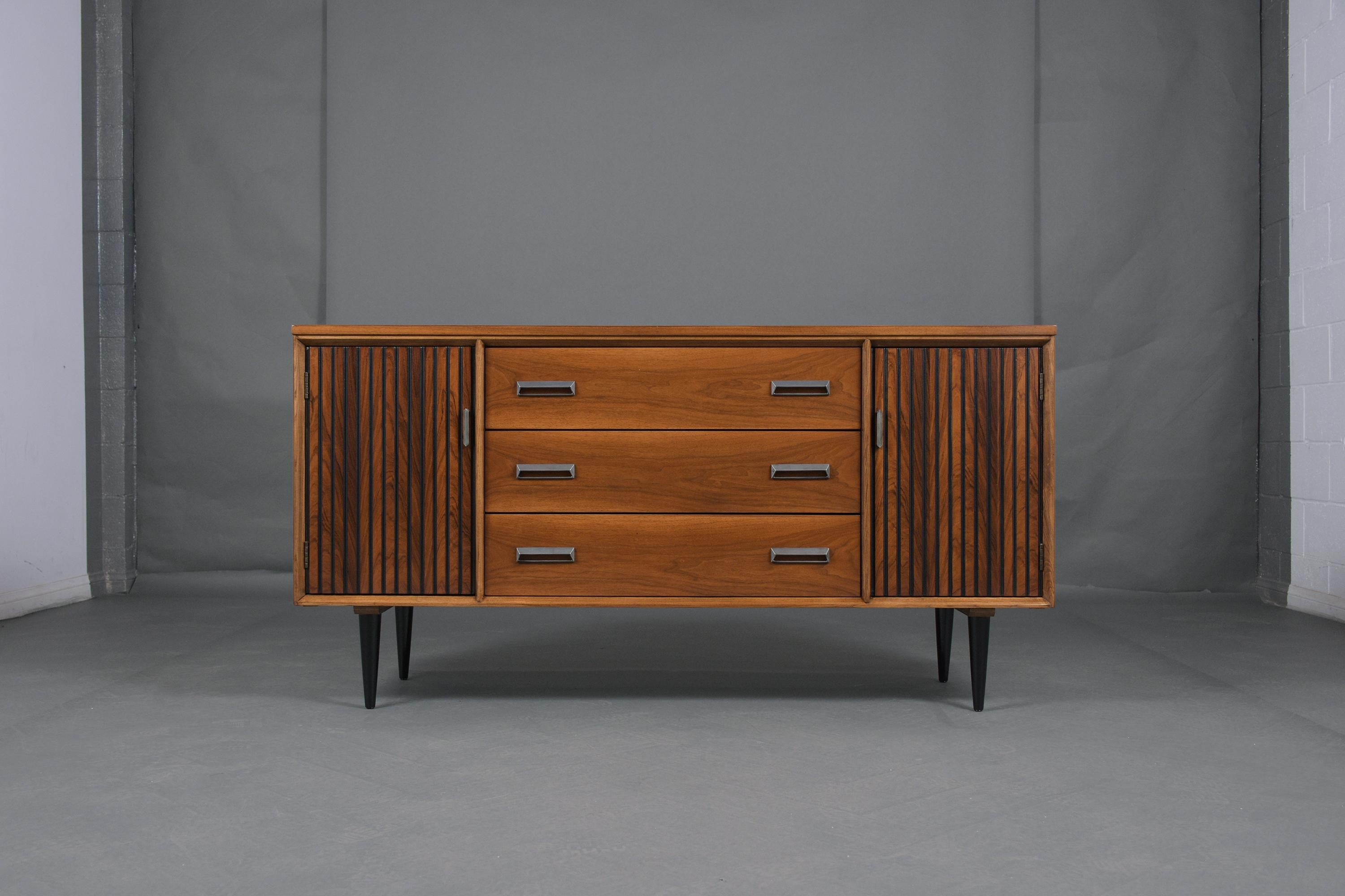 An extraordinary danish credenza hand-crafted out of rosewood and has been professionally restored by our team of expert craftsmen. This piece features three large pull-out drawers that open and close with ease each with double steel handles, two