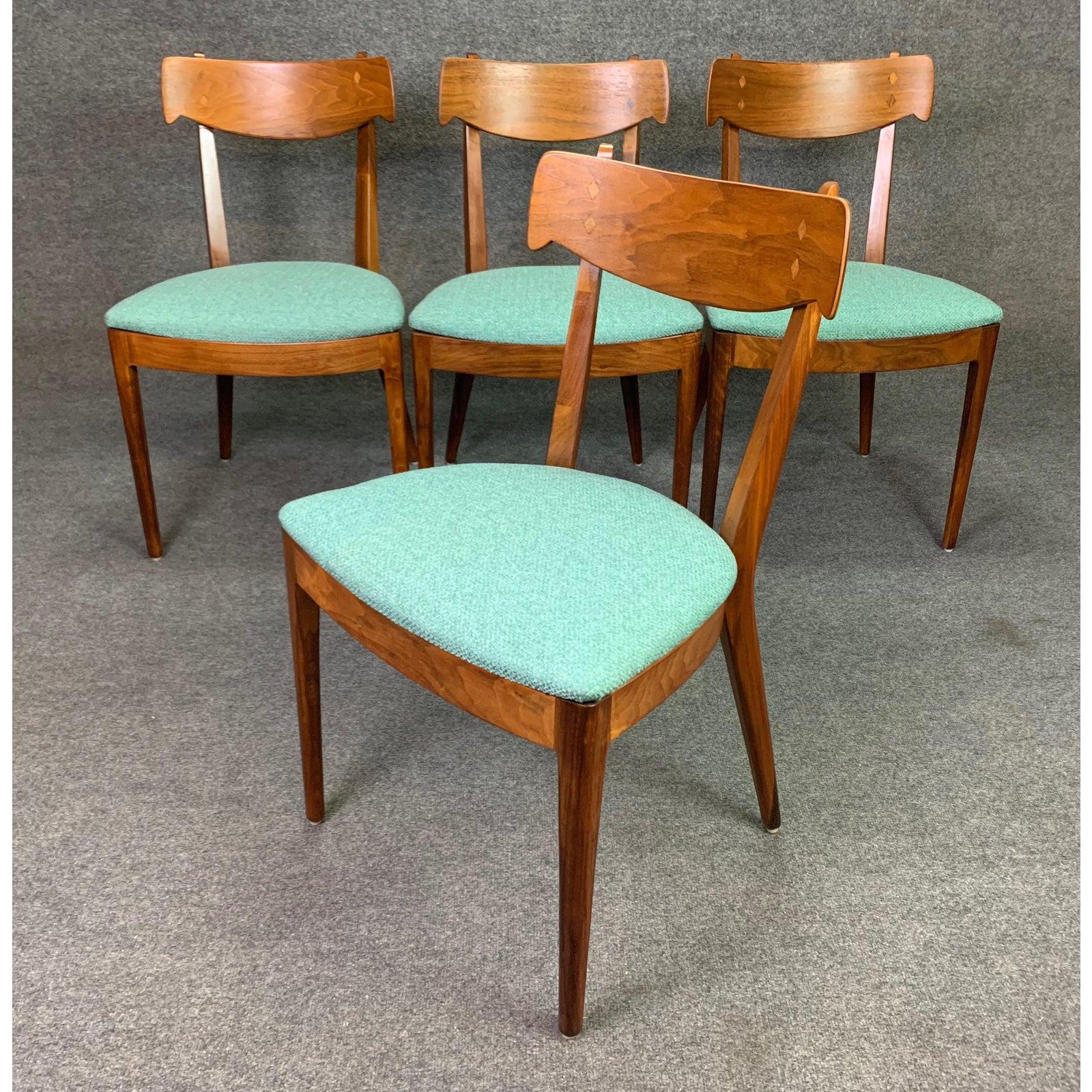 Here is a beautiful midcentury set of four dining chairs in walnut part of the 