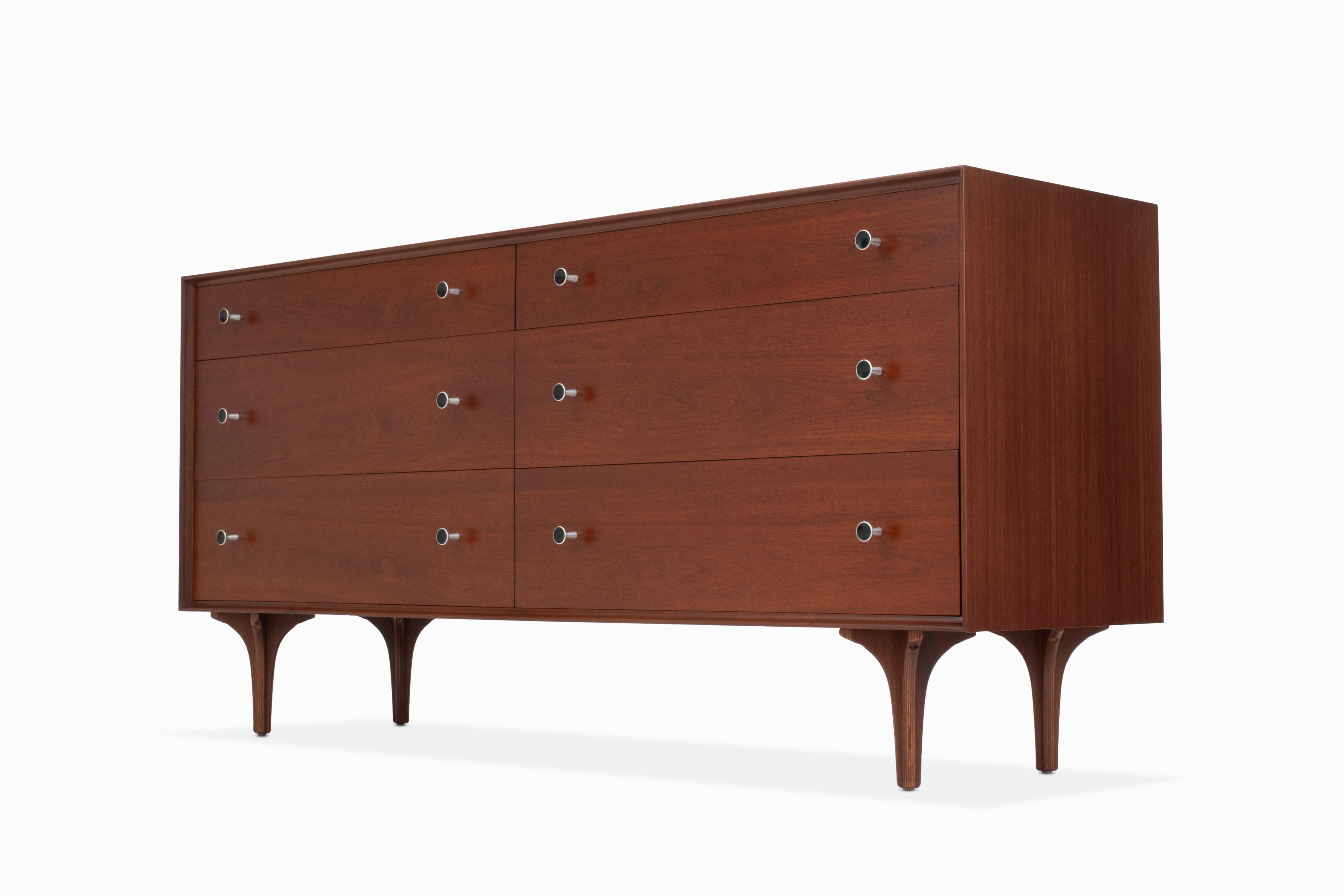 Here is a lovely and uncommon walnut dresser designed by Robert Baron for Glenn of California. It is in beautiful refinished condition, featuring 6 large drawers (2 with dividers), hourglass aluminum pulls with enamel detail and uniquely sculptural