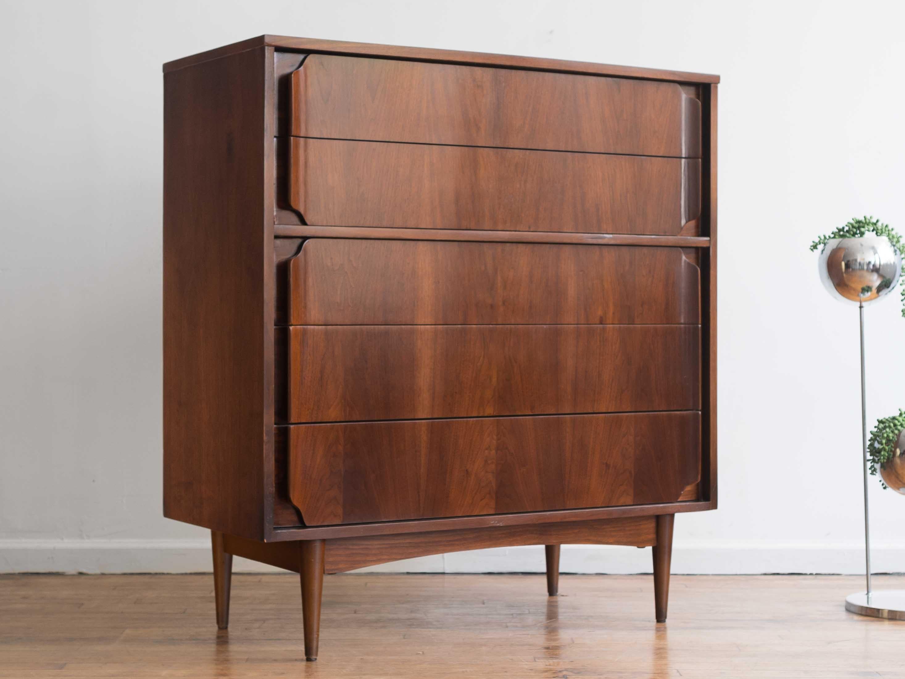 35” x 18” x 43.5”H

This vintage MCM Lane Rhythm highboy dresser is crafted from walnut and features five spacious drawers with full-length, curved wooden pulls and sits atop offset, tapered legs. 

This piece has been carefully restored and is