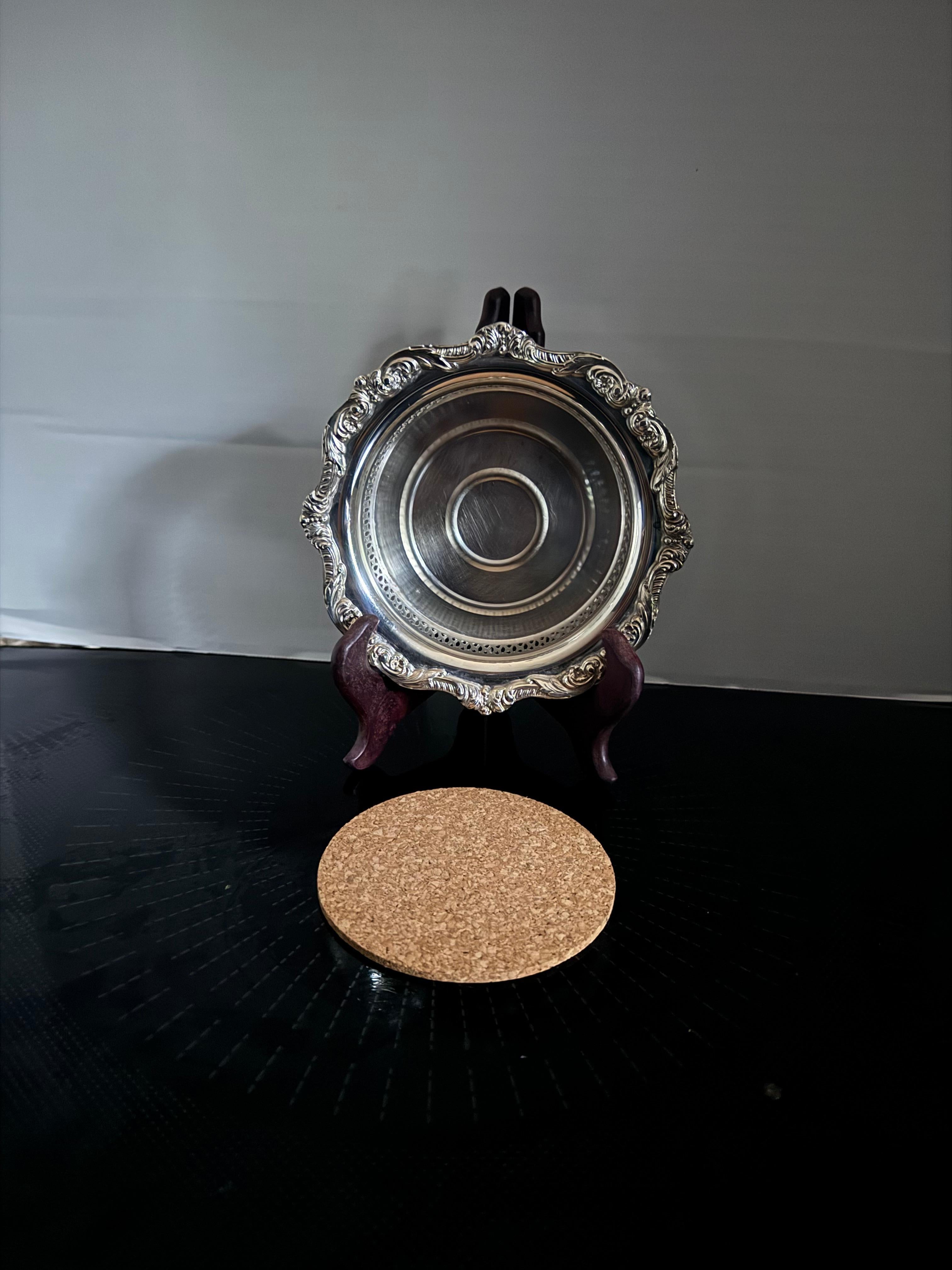 Preowned vintage silver plate wine coaster withb ornate rococo design on the rim , it is made by poole , which is marked at the bottom.  Wine coasters help to ensure that any residual drops of wine are collected by your coaster. Not only do they