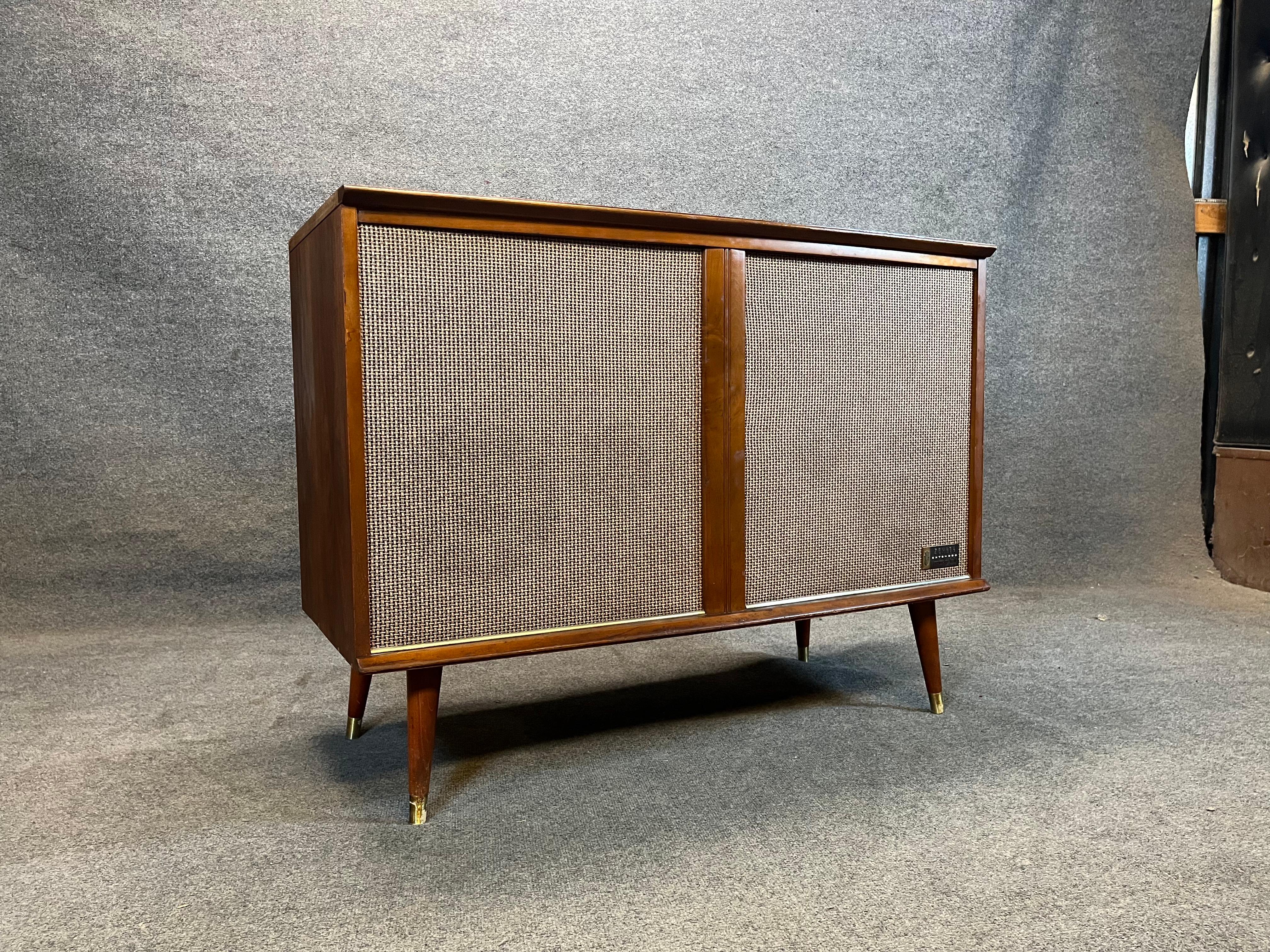 Mid Century Modern Stereo Console By Zenith - Record Changer - AM/FM- Tube Amplifier. This is a great design; stunning visuals and lines plus solid mid century quality that would be a FABULOUS addition to your mid century decor. 

Record player has