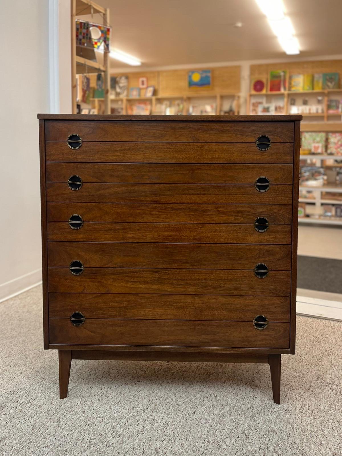 Mid Century Tall Dresser with Four Dovetailed Drawers.The Middle Drawer is Deeper than the Rest as Shown. Tapered Legs, original Round Handles. Vintage Condition Consistent with Age as Pictured.

Dimensions. 37 1/2 W ; 18 D ; 43 H