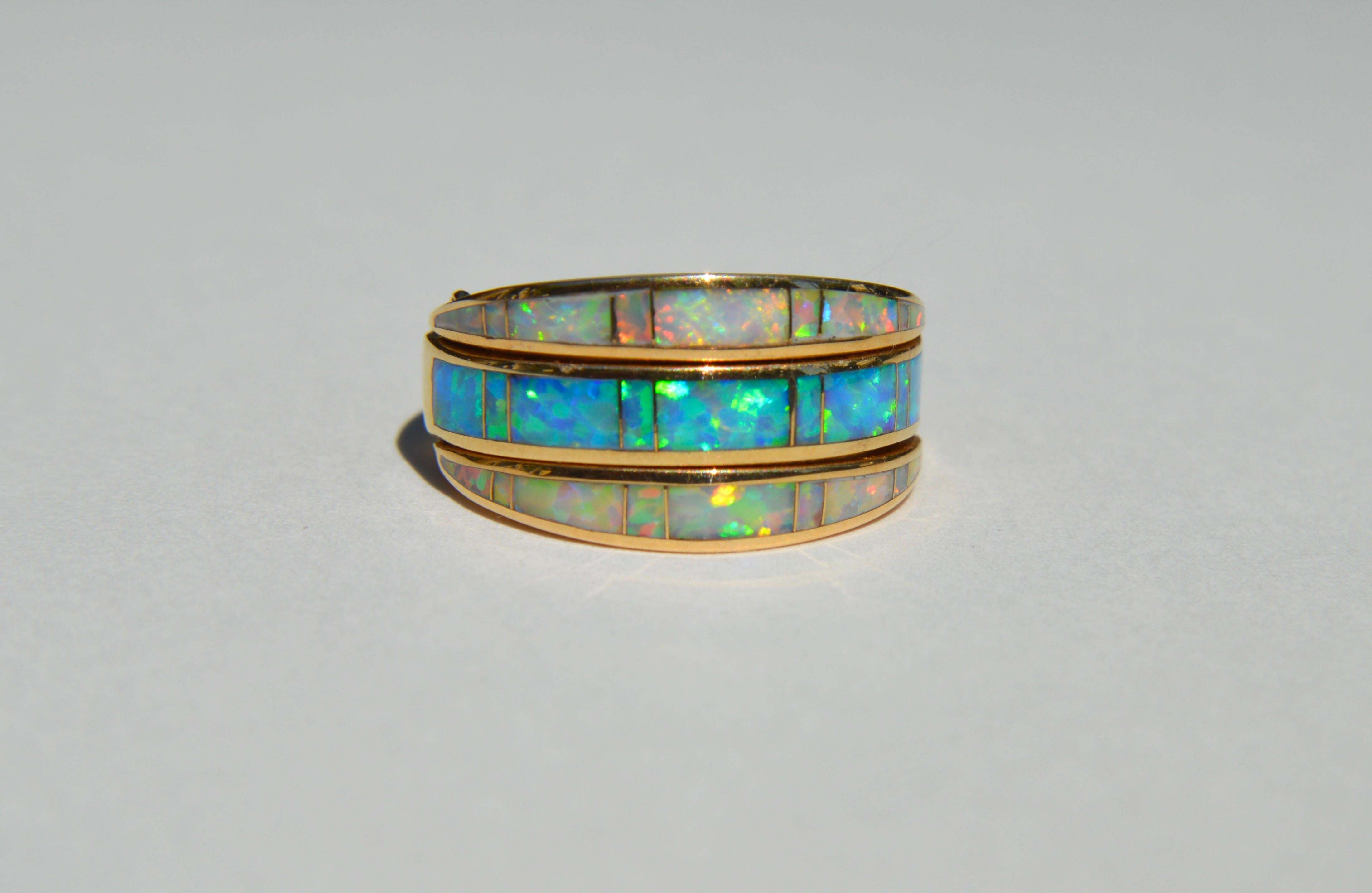 Lovely vintage Midcentury era circa 1970s Australian opal 14K yellow gold flip band bring. Size 5, cannot be resized. Marked and tested as 14K gold. In very good condition. Can be worn two different ways. The opals are exceptionally fiery and full