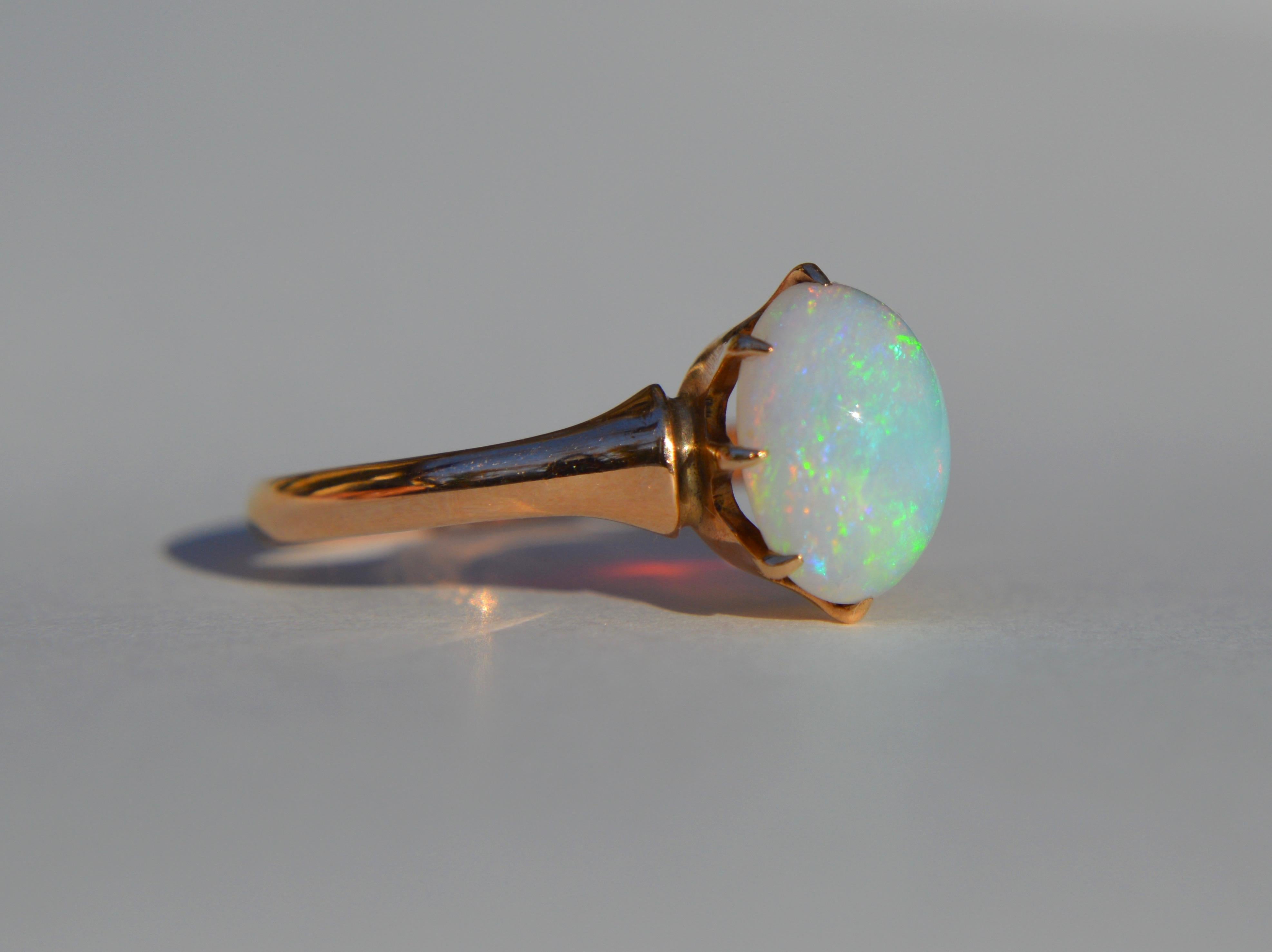 Beautiful vintage circa 1950s midcentury Australian 2.54 carat opal cabochon ring in solid 10K rose gold. In very good condition. No scratches or wear to the opal. Weighs 2.4 grams. Size 7.75, can easily be resized by a jeweler. Opal measures