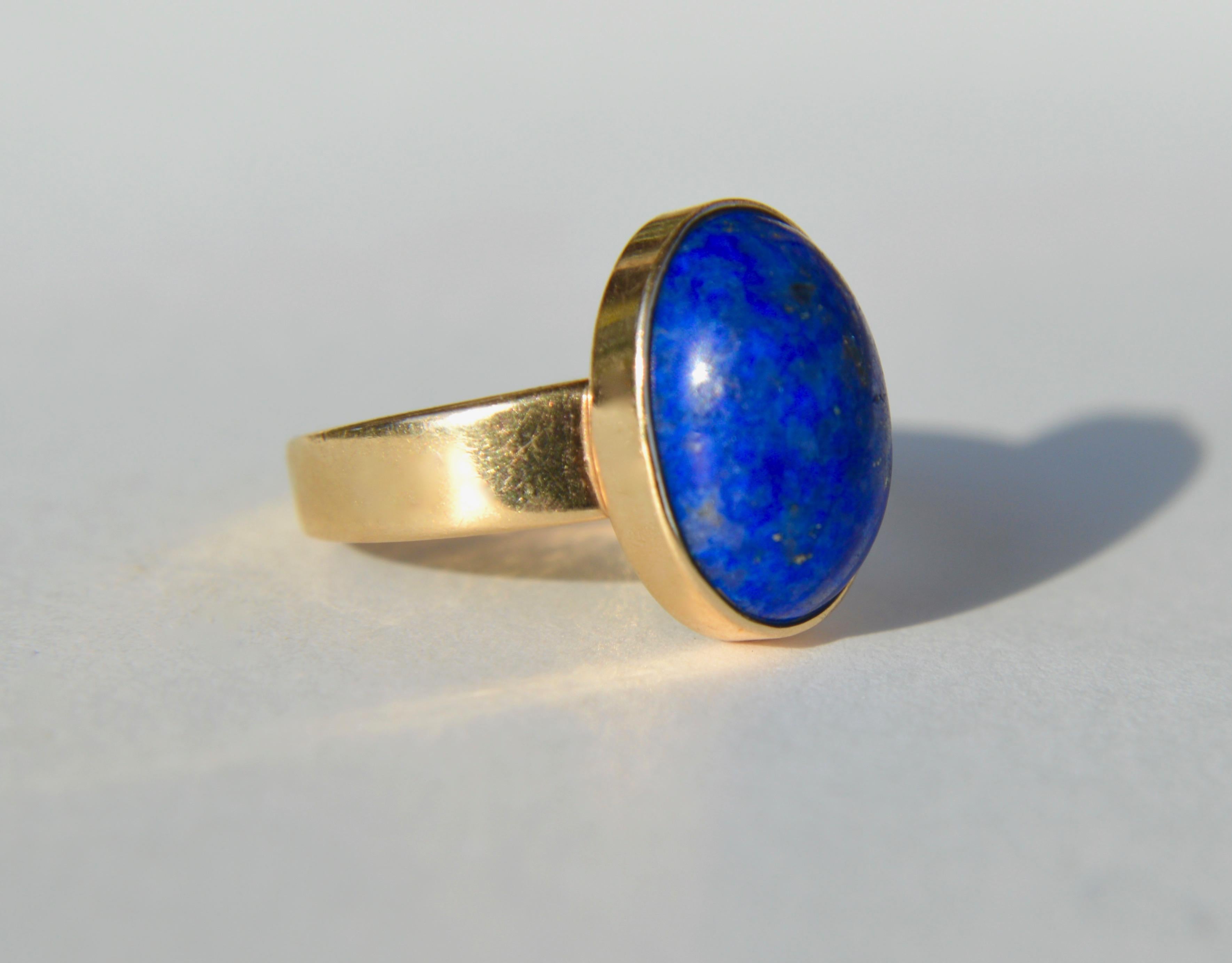 Beautiful modern vintage circa 1960s 5.81 (14x10mm) carat lapis lazuli 14K yellow gold solitaire cabochon ring, Size 6, can be resized by a jeweler. In very good condition. Stamped as 14K gold. 

All items arrive in a black with gold logo gift box.