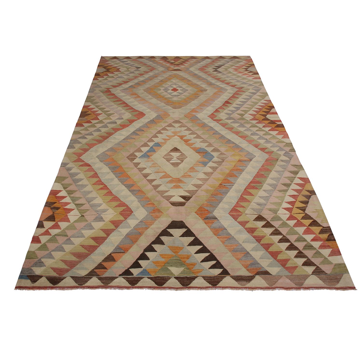 Flat-woven in Turkey originating between 1950-1960, this vintage midcentury tribal Kilim hails from the province of Afyon, enjoying the marriage of an idyllic diamond pattern with unique cream-pink, beige and blue hues. Further complemented by