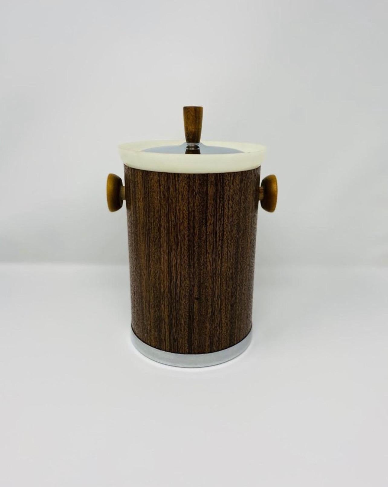 Vintage midcentury kromex ice bucket. This stylish ice bucket features wood veneer wrapping with plastic trim and chrome lid and base with 2 wooden handles. Entertain guests while keeping your favorite wine cool and ready. excellent condition .