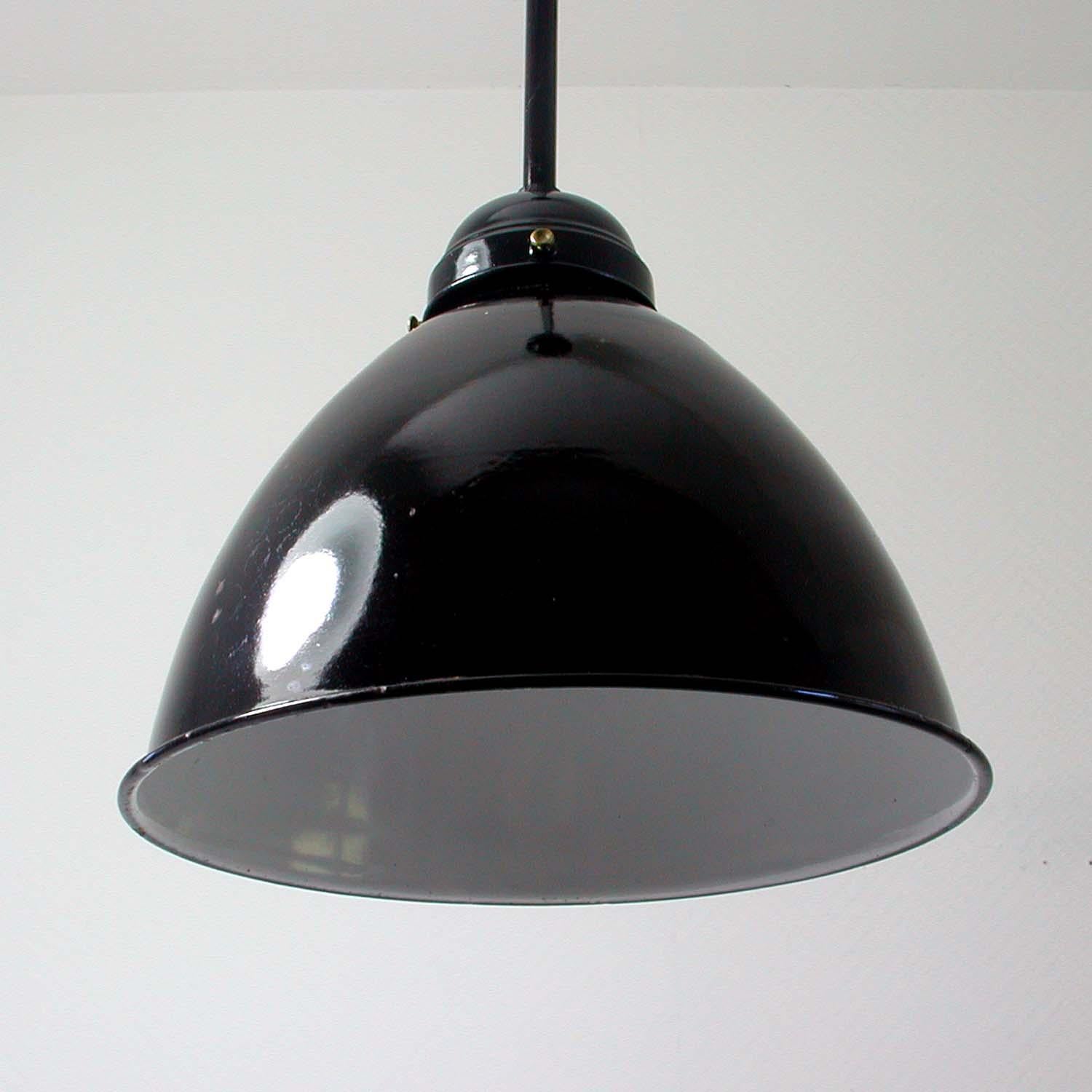 This vintage industrial ceiling light was made in Germany in the 1940s-1950s. The lamp has got a black enamel lamp shade (inside is white enamel) with black lacquered lamp rod and black lacquered canopy.
Rewired for use in US, Europe and Asia.