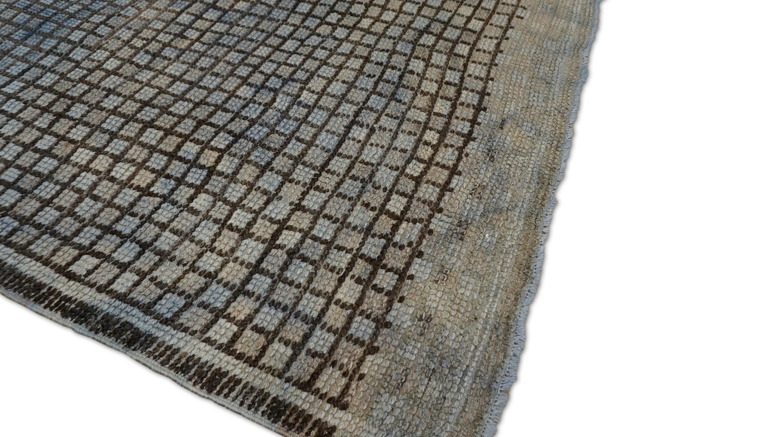 This hand-knotted wool rug showcases a bold and contemporary grid design, reinterpreted through a vintage weaving tradition. Rug features a rhythmic linear pattern of hand-drawn-like squares in charcoal Brown  over a softly faded ground of green,