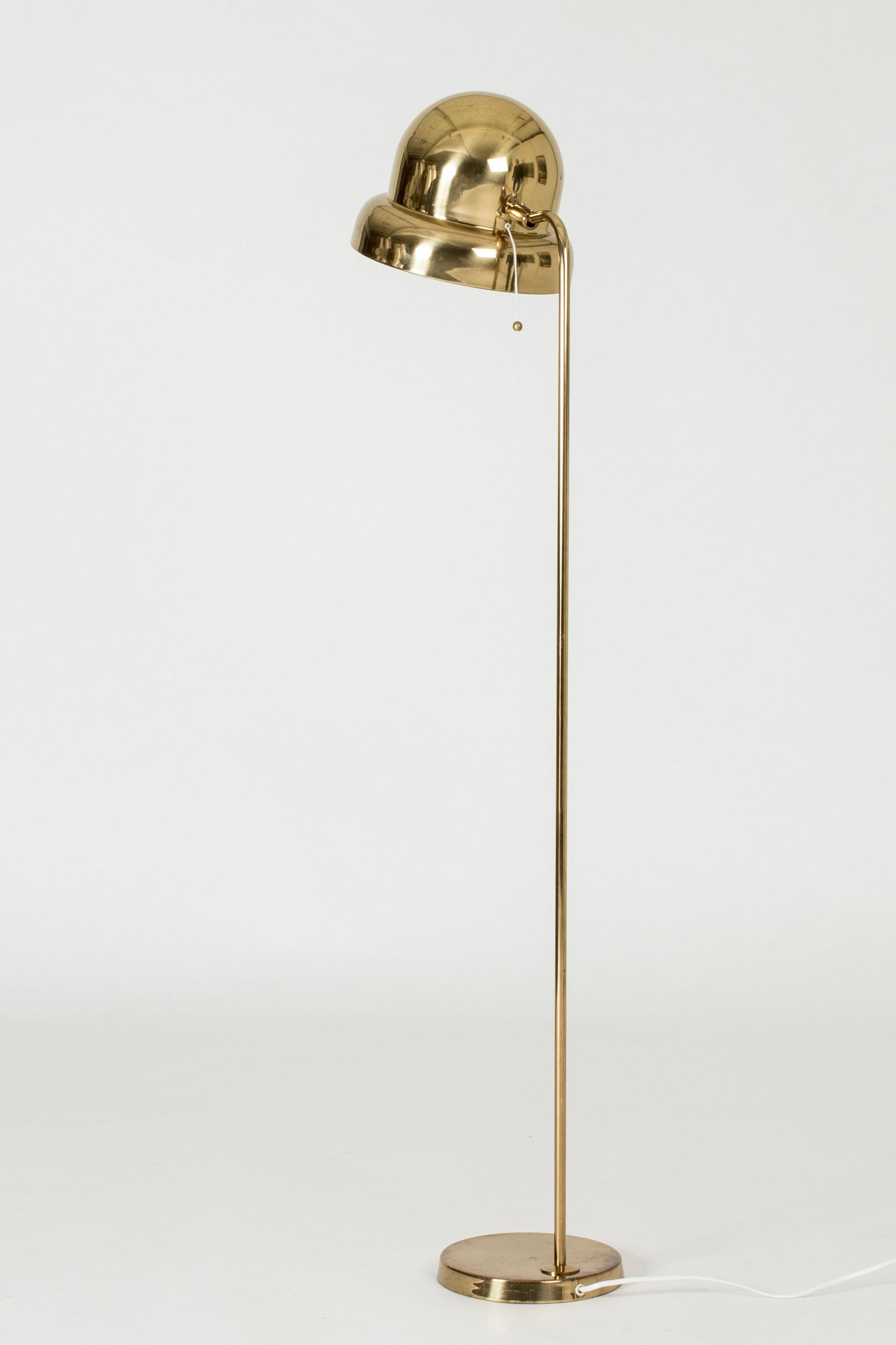 Cool brass floor lamp from Bergboms, with a lampshade in a rounded, organic form. White lacquered inside.