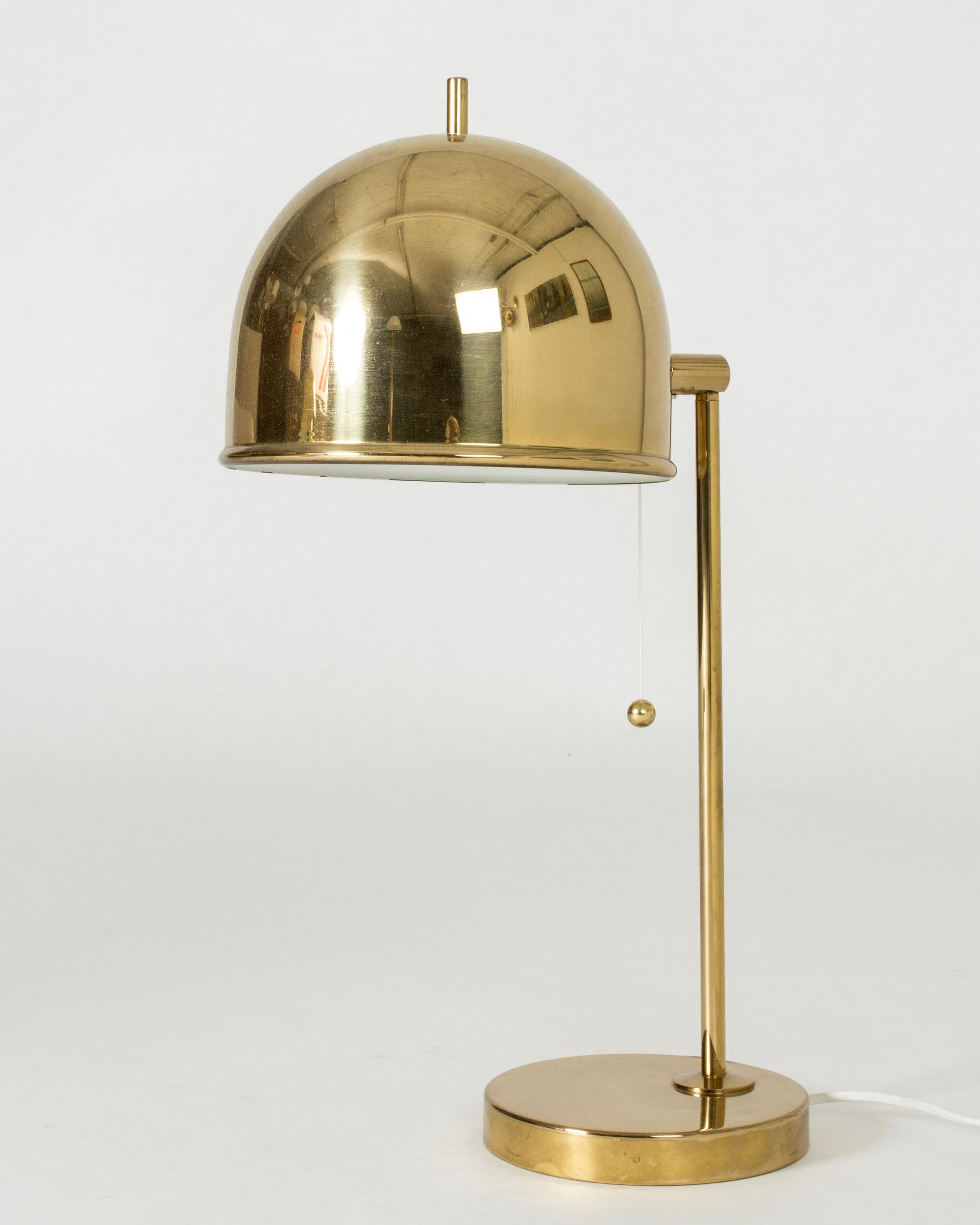 Brass table lamp from Bergboms with a dome shaped shade and strict lines. The little tip on the top of the shade is a fun detail.