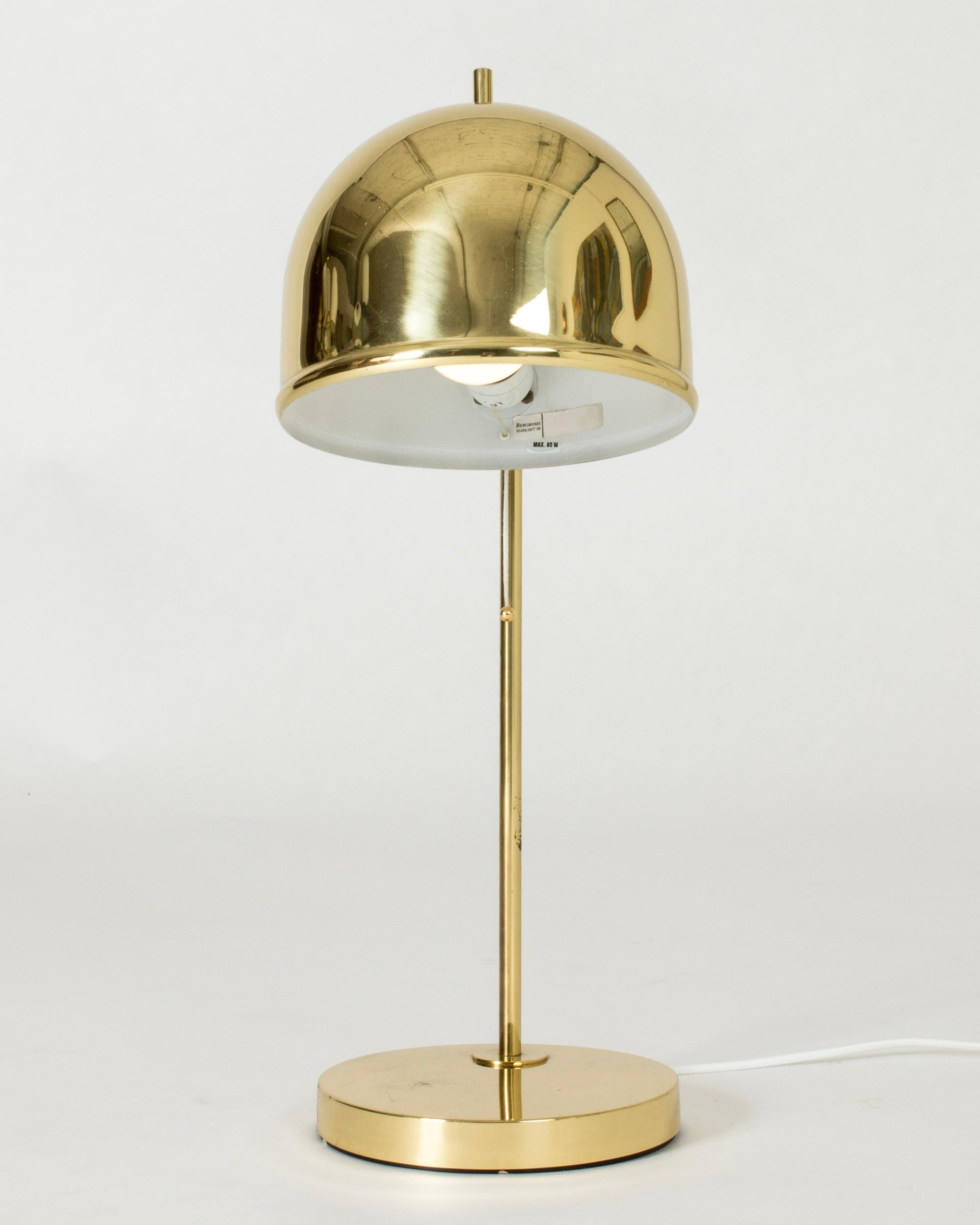 Brass table lamp from Bergboms with a dome shaped shade and strict lines. The little tip on the top of the shade is a fun detail.