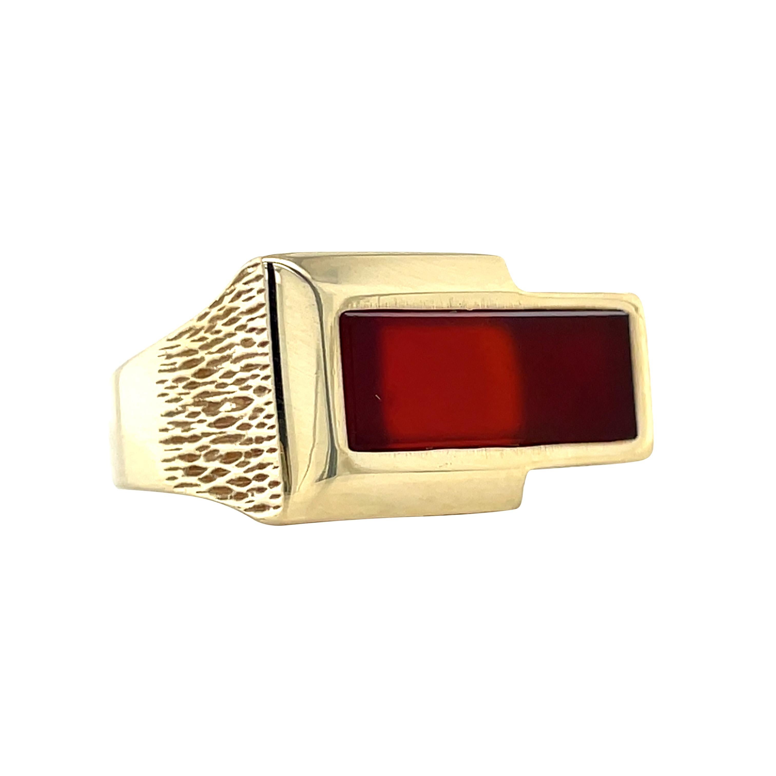 A solid signet ring ready to make a statement, this vintage ring turns the signet ring tradition on its head, adding a twist to the centuries-old style by setting the center gemstone east-west instead of the traditional north-south. Textured