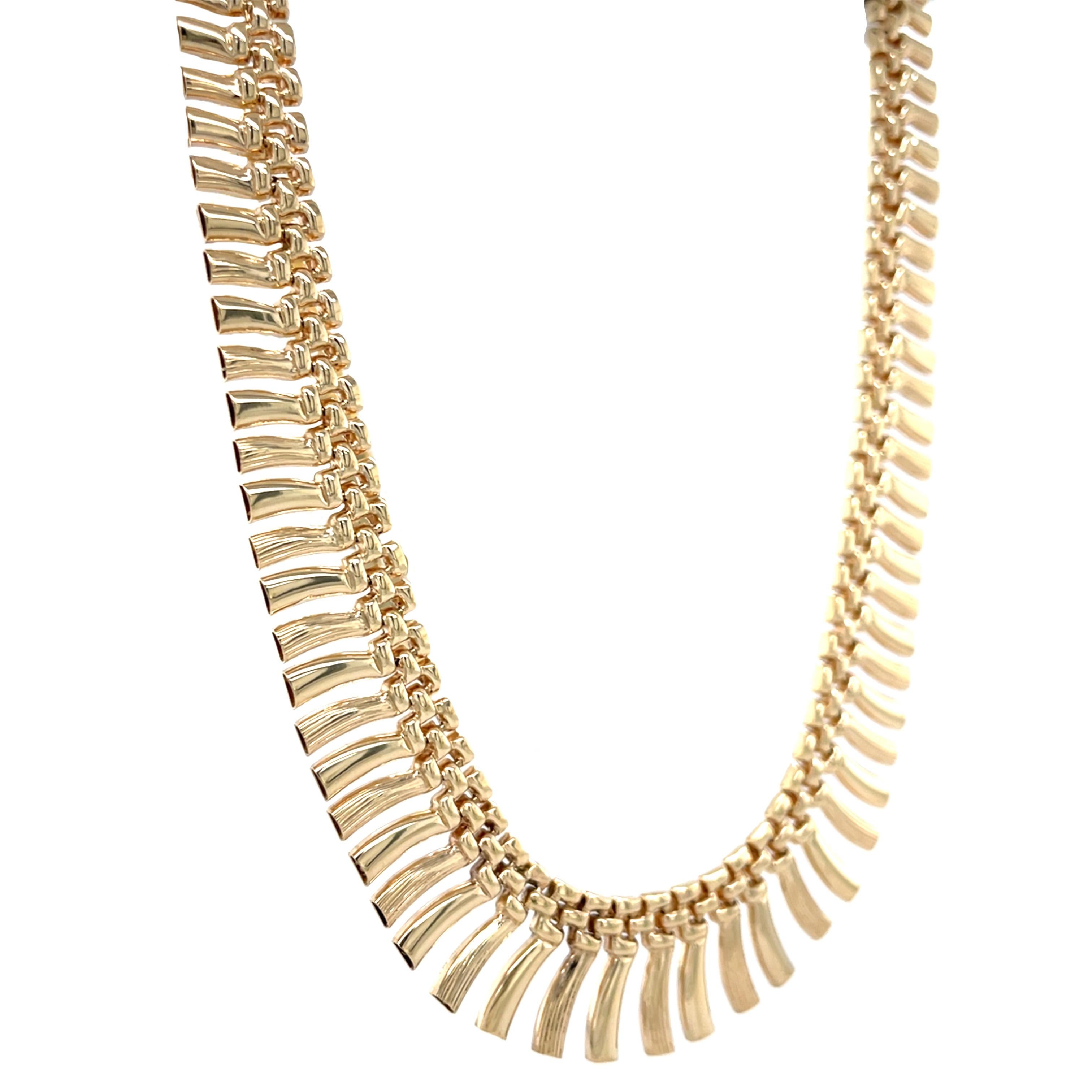 A MidCentury marvel, this collar necklace is such a statement! Graduated links create a beautiful fringe look, perfect to pair with either a t-shirt and jeans, or as the finishing jewel with your favorite fancy dress. 

Exquisitely rendered in 14