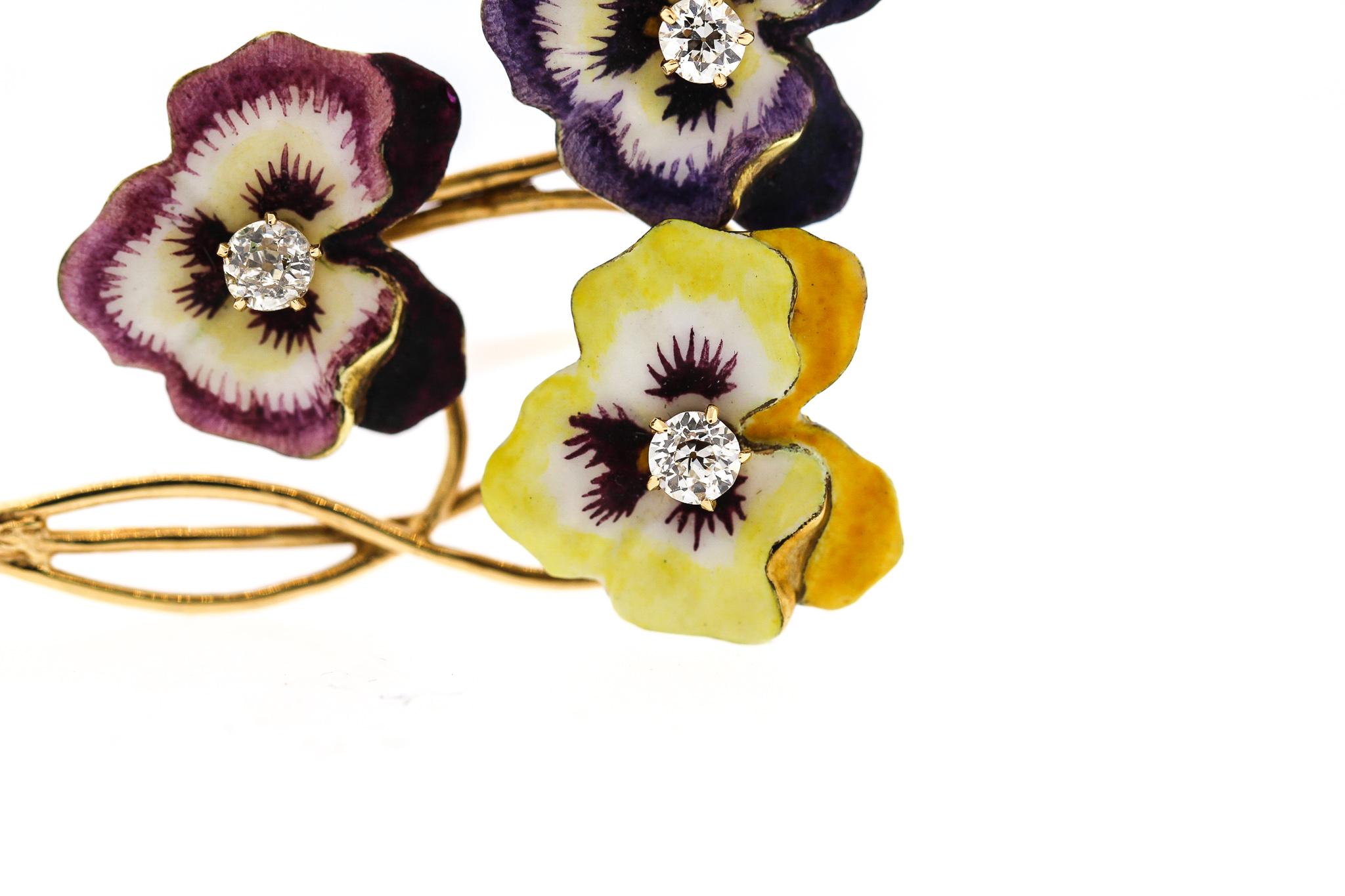 A vintage three pansy flower brooch set with old cut diamonds on 14k gold, circa 1950. A yellow and two purple pansies are set with old cut round diamonds weighing about 0.12 ct each (0.36 ct total). The pansies are enamel on 14k gold and long stems