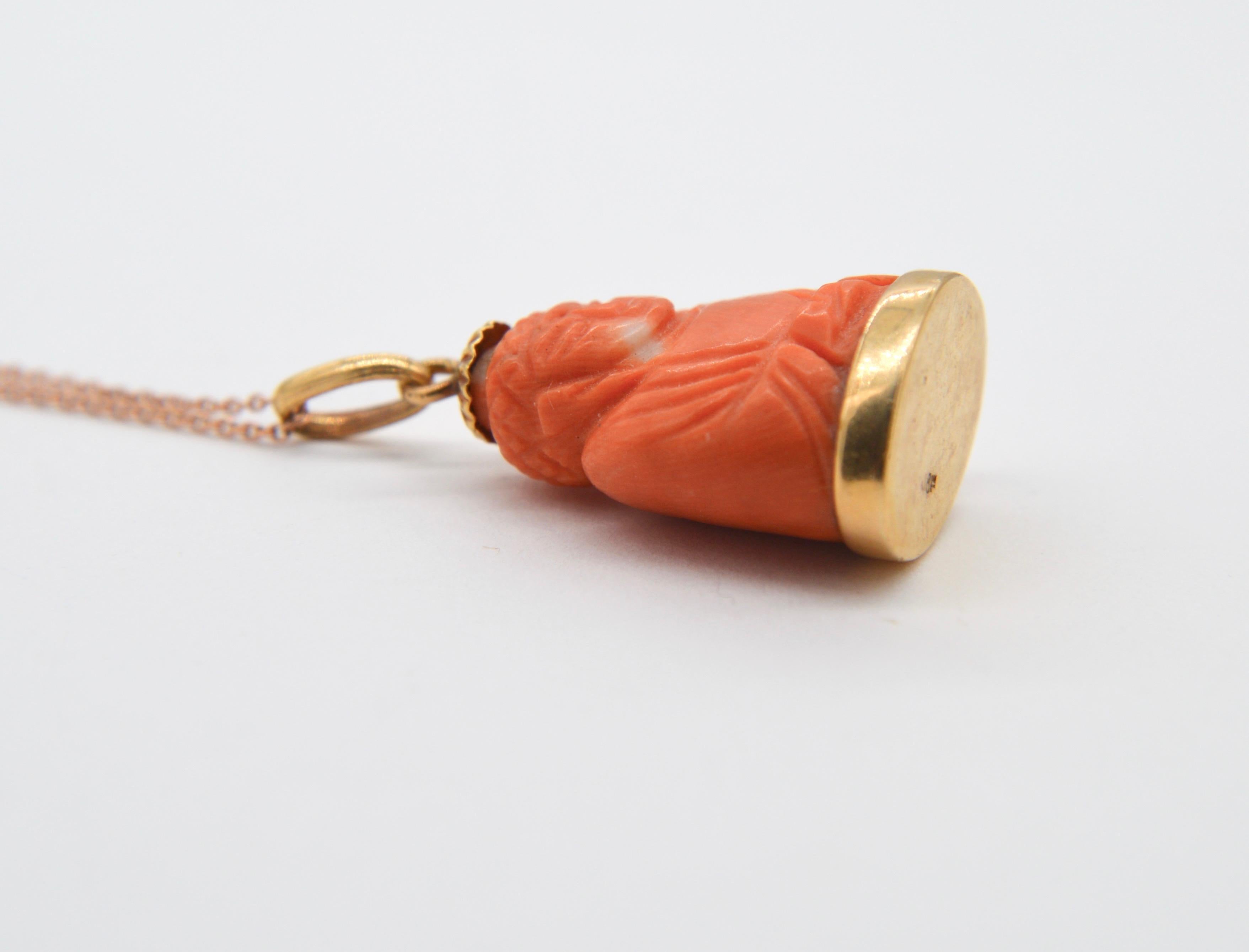 Lovely vintage Buddha natural coral charm pendant, circa 1960s set in solid 18K yellow gold. Chain not included. Marked as 18K. In very good condition. 1