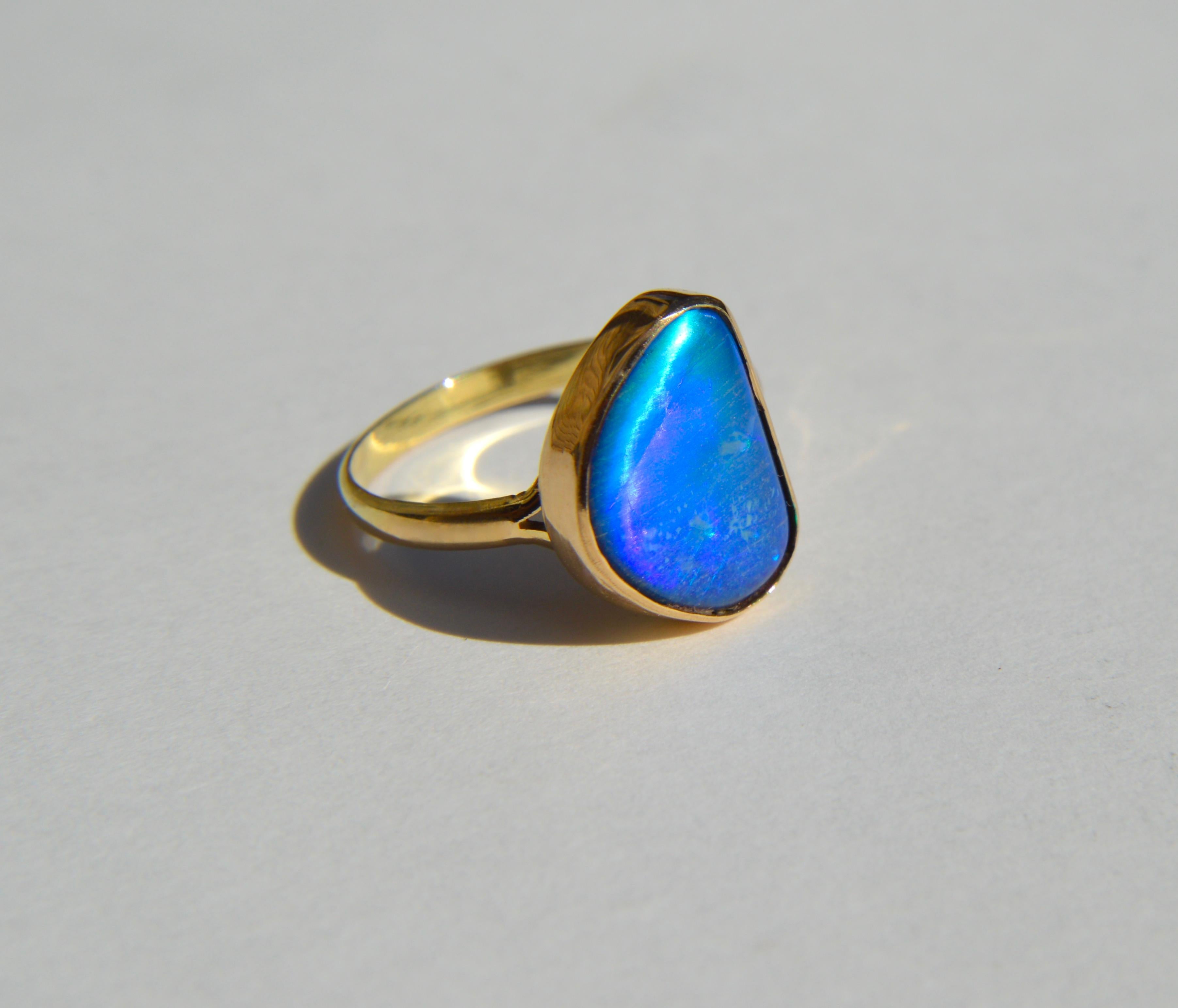 Vintage midcentury era circa 1960s stunning freeform blue boulder opal ring in 14K yellow gold. Opal measures 13x10mm. Size 6, Can be resized by a jeweler. Ring is unmarked but tested as solid 14K gold. In very good condition. Ring weighs 2.41