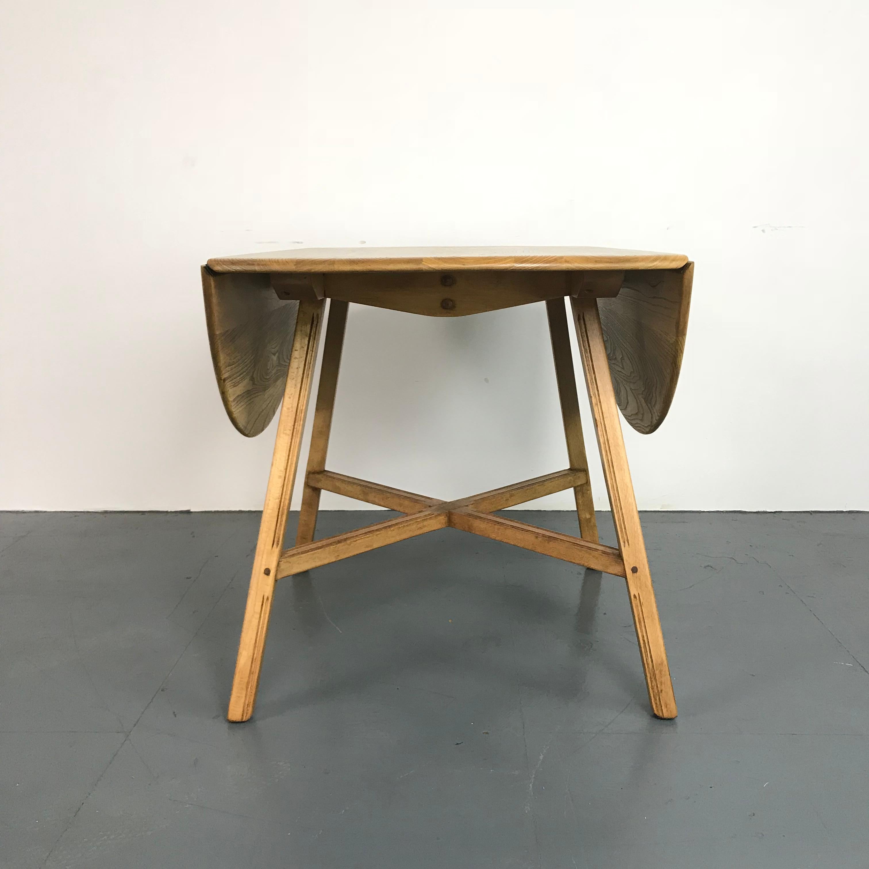 Lovely vintage (mid-1960s) Ercol round drop leaf dining table. Lovely elm top on beech legs. Beautiful patina to the wood. 

This has been fully restored so is in very good vintage condition. It's a vintage item, so has some general age-related