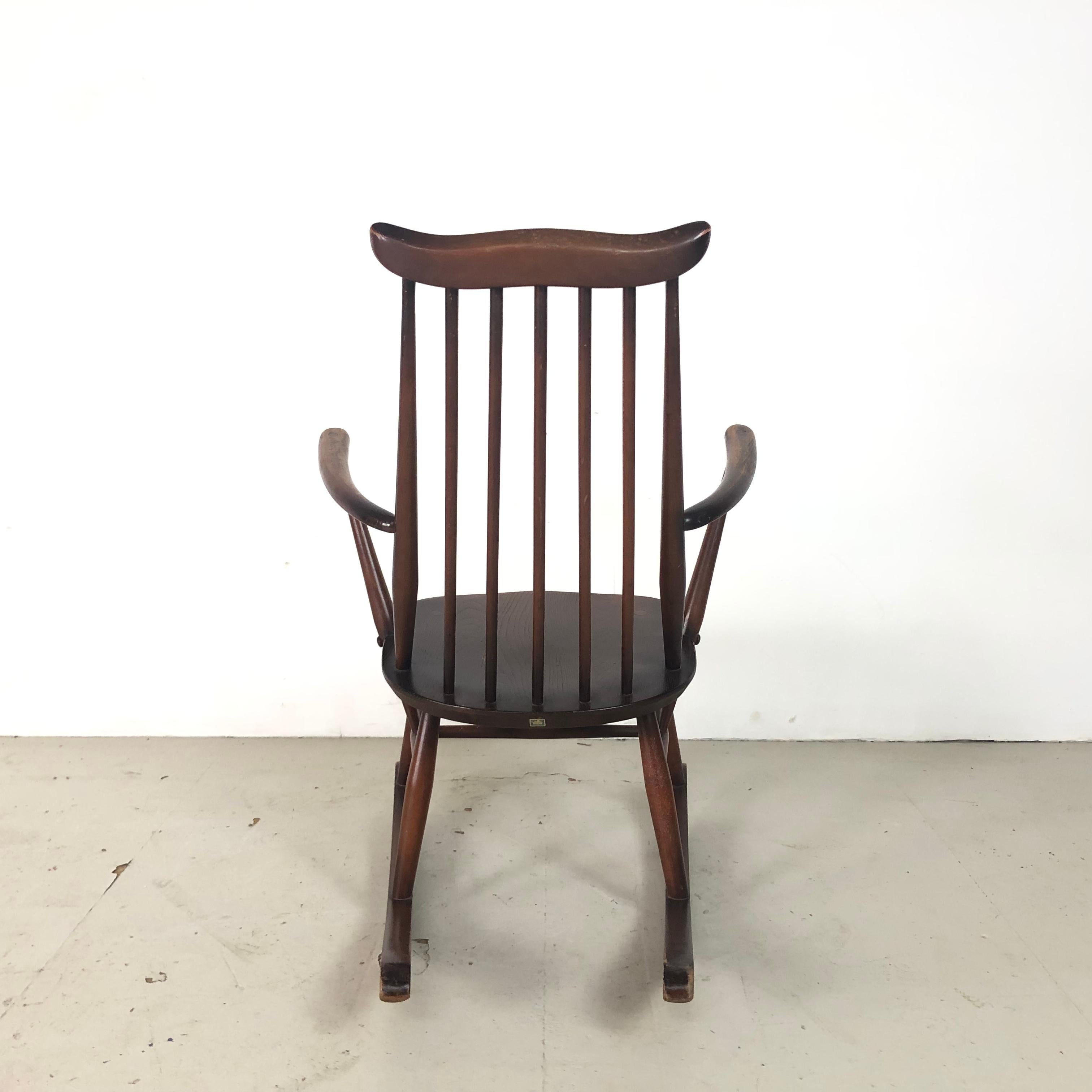 Lovely early Ercol rocking chair made of dark stained elm veneered ply with a bent elm frame. 

In good vintage condition. Some wear and tear as to be expected but nothing noticeable and nothing which detracts.

Approximate dimensions:

Height