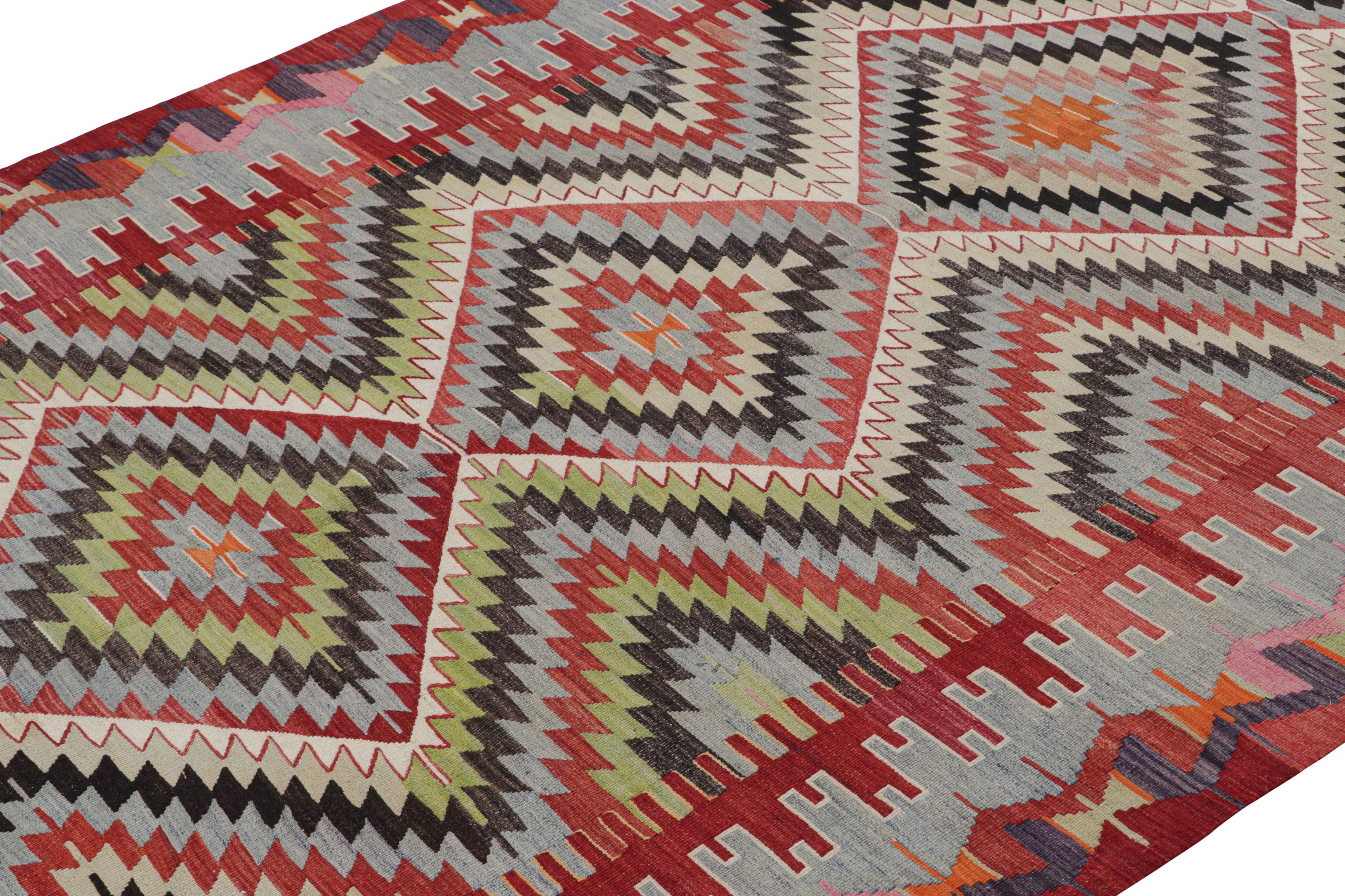 Flat-woven in Turkey originating between 1950-1960, this vintage midcentury Kilim hails from the town of Esme, a visually grasping play on the traditional diamond design complemented by the lively white, pink and green accents to the arresting