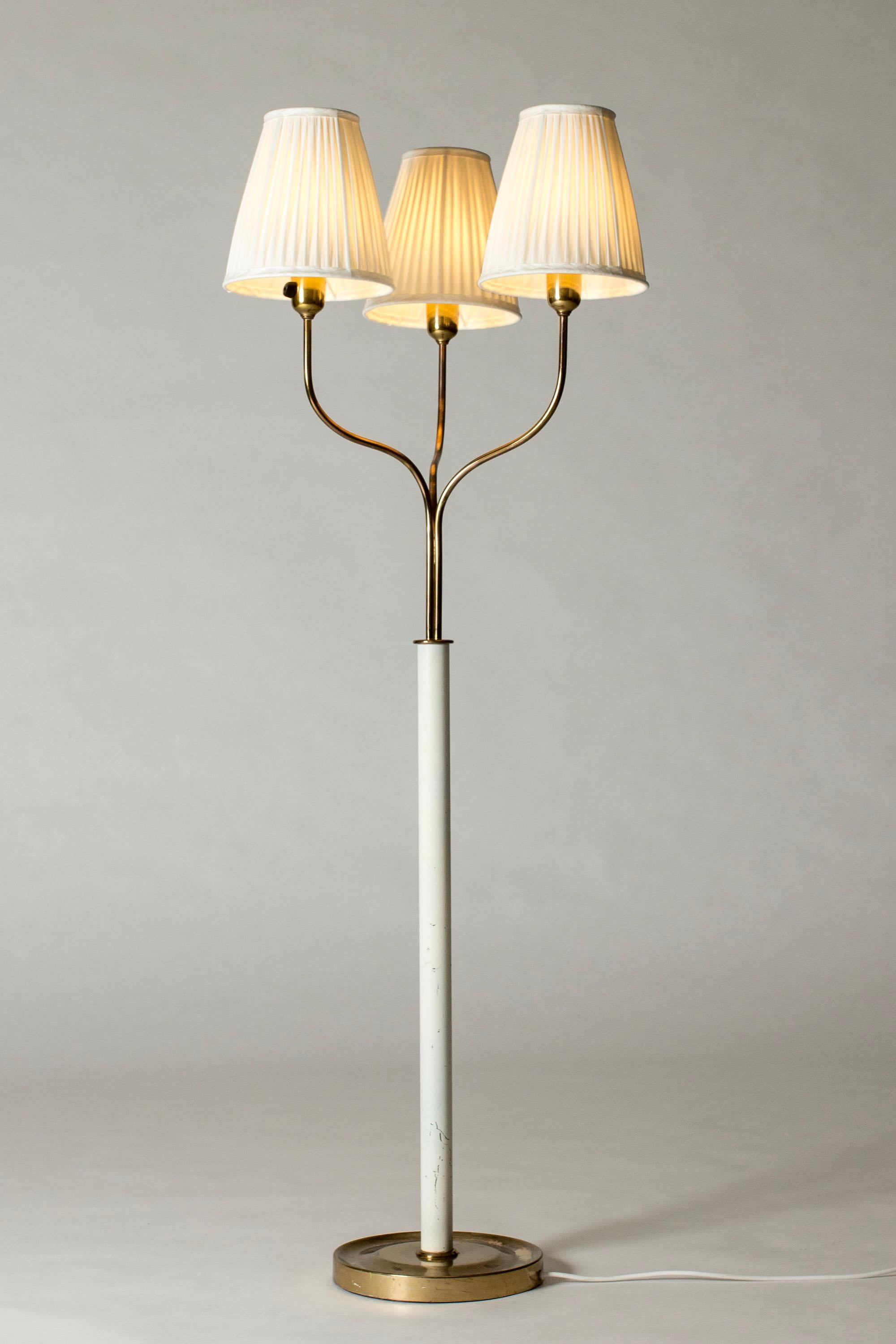 Beautiful floor lamp by Josef Frank, made from brass with a white lacquered stem. Three lights with pleated shades, weighty brass base.