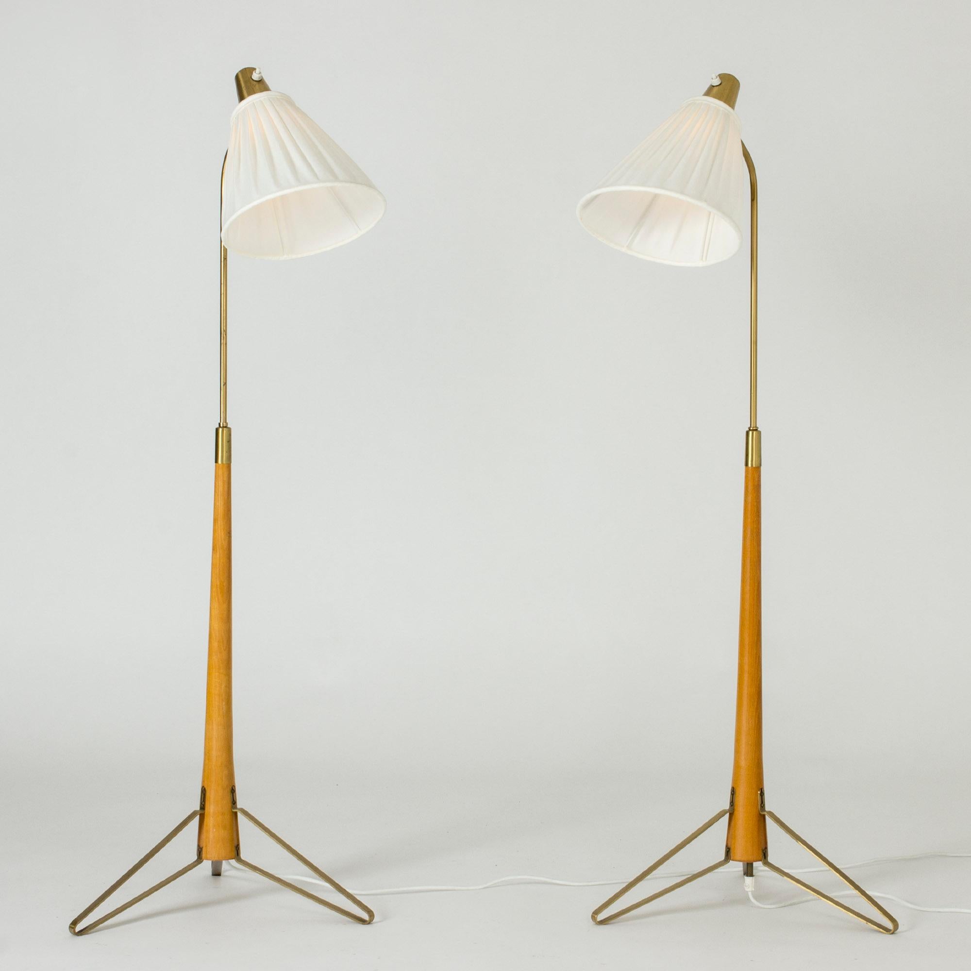 Pair of brass floor lamps by Hans Bergström, with beech handles and elaborately folded brass feet.

The lamps have the same lowest height, 116 cm, but can be adjusted to different heights, 137.5 and 146.5 cm.

Hans Bergström was the owner and